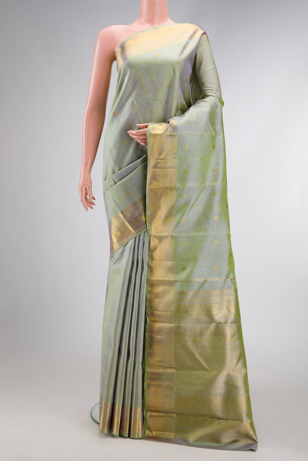 Pure Silk Pure Zari Pista Green Dual Tone Kanjivaram Saree with Zari Butta on the body and Zari Border.  displayed on a mannequin