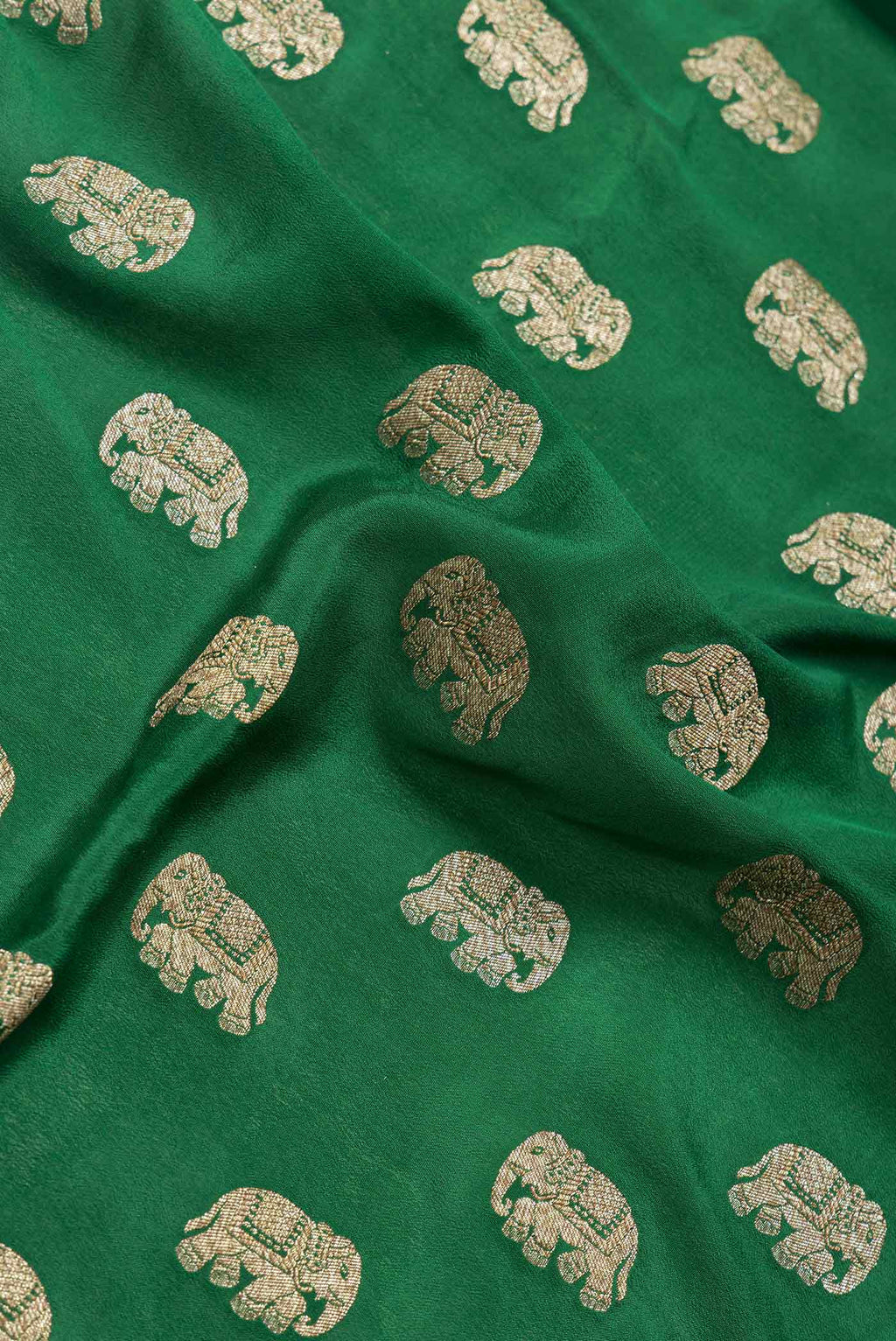 Close up of Green Dual Tone Banarasi Georgette Saree with Zari Butta on the body and Zari Border.  displaying folds