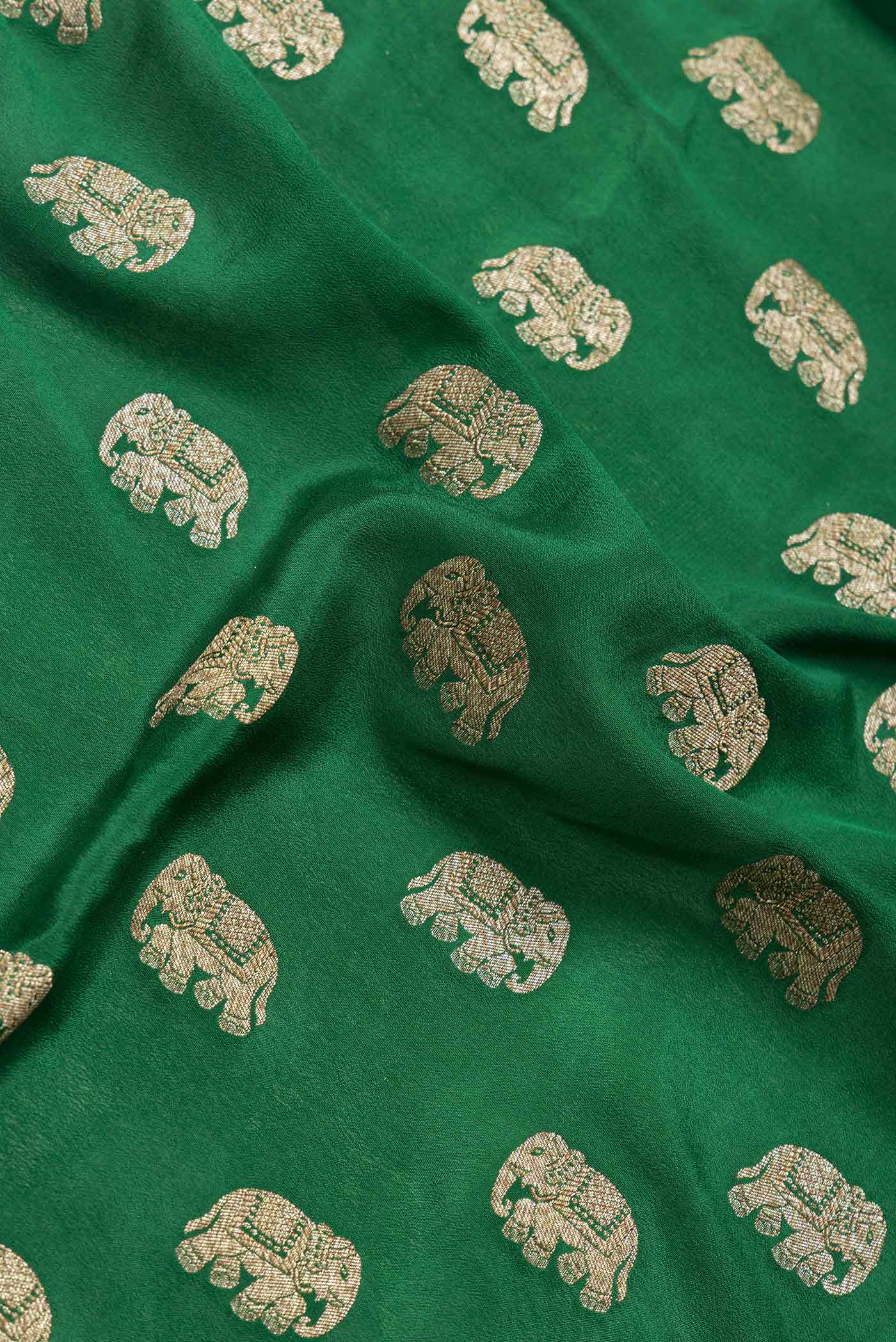Close up of Green Dual Tone Banarasi Georgette Saree with Zari Butta on the body and Zari Border.  displaying folds