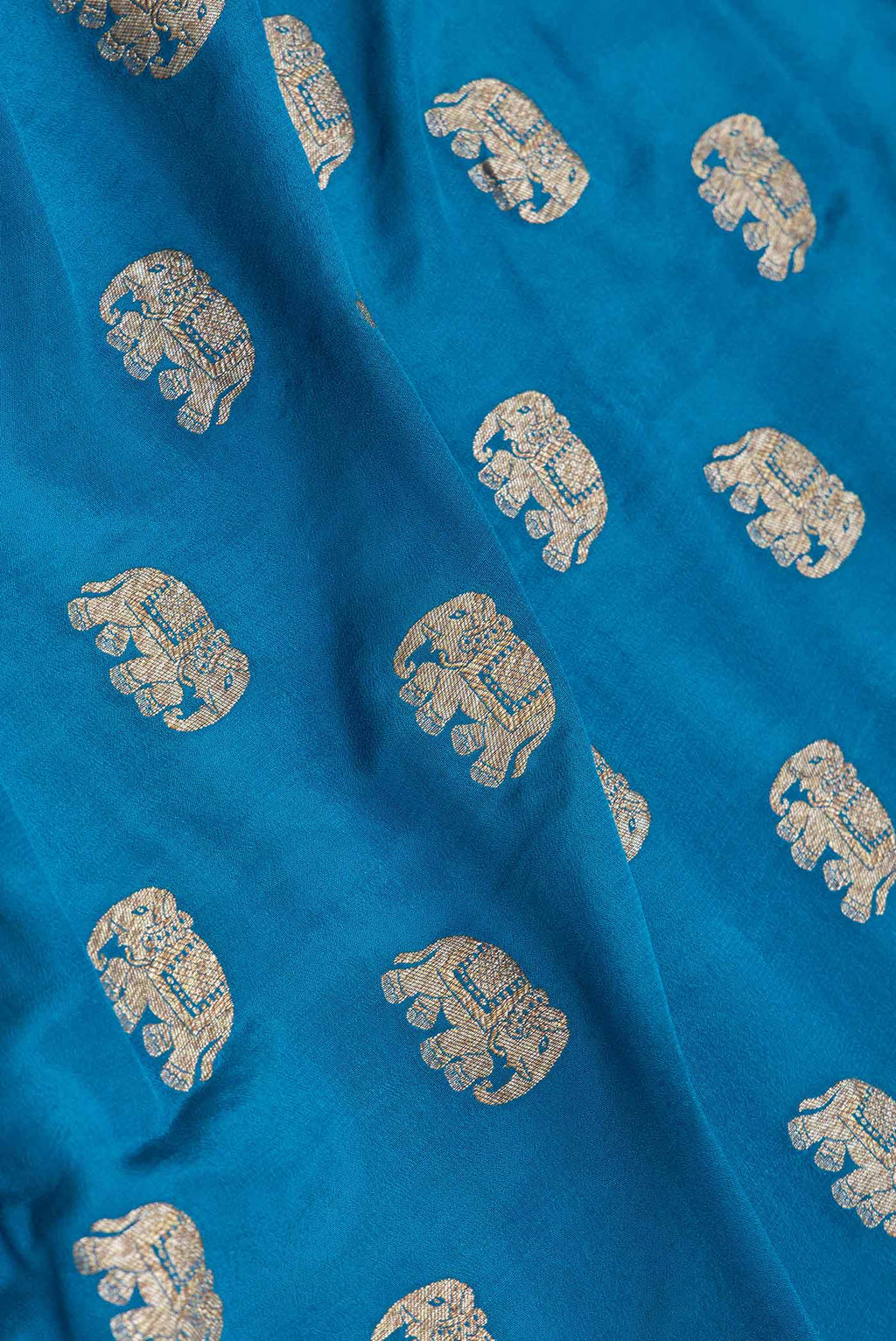 Close up of Sky Blue Dual Tone Banarasi Silk Saree with Zari Butta on the body and Zari Border.  displaying folds