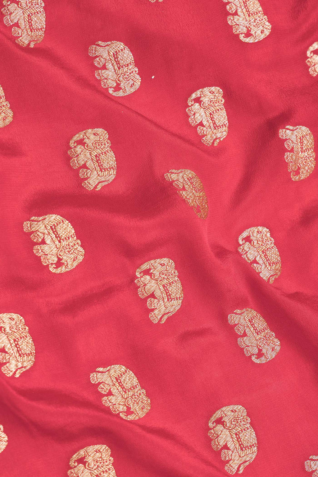 Close up of Red Dual Tone Banarasi Georgette Saree with Zari Butta on the body and Zari Border.  displaying folds