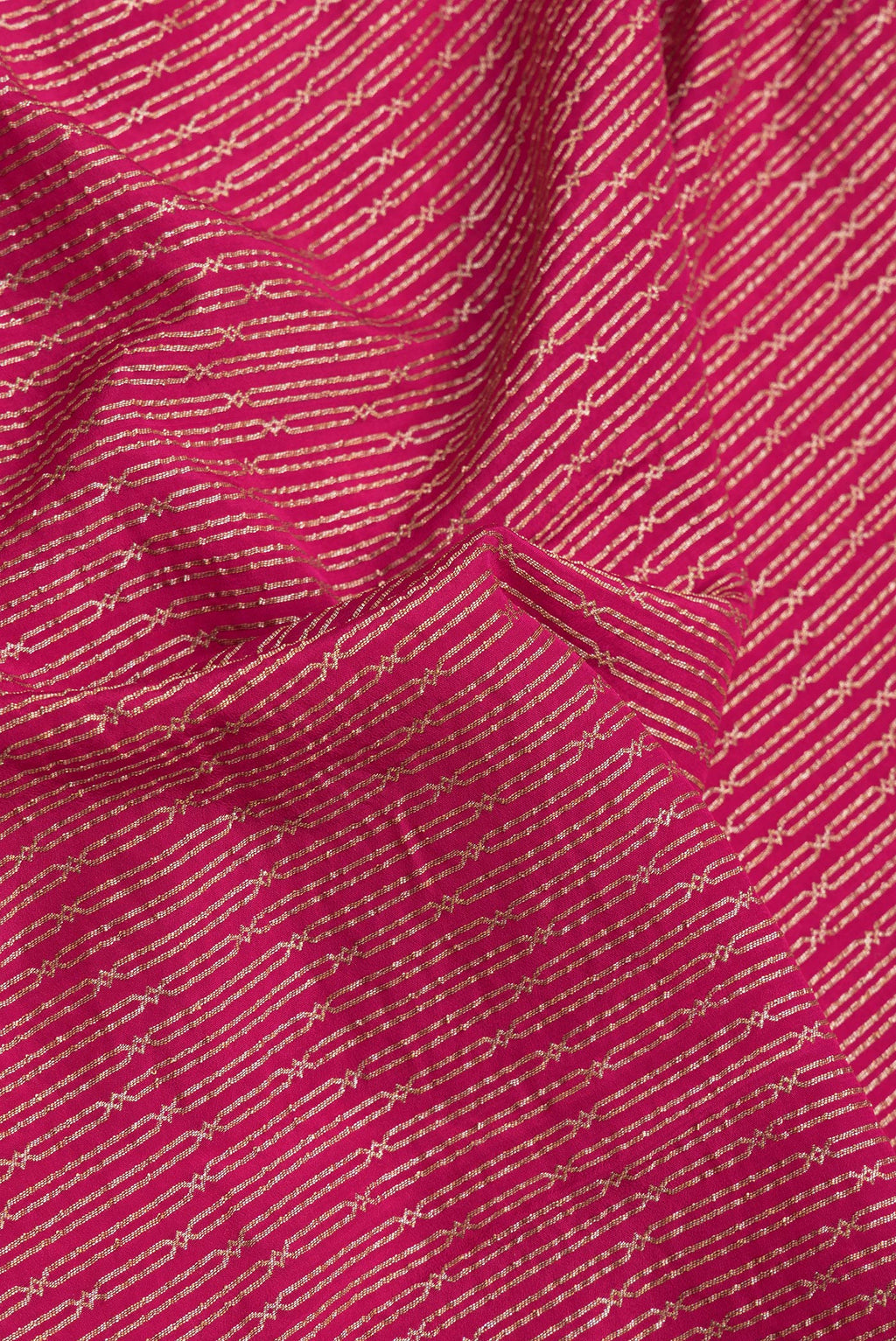 Close up of Dark Pink Dual Tone Banarasi Georgette Saree with Zari Brocade on the body and Zari Border.  displaying folds