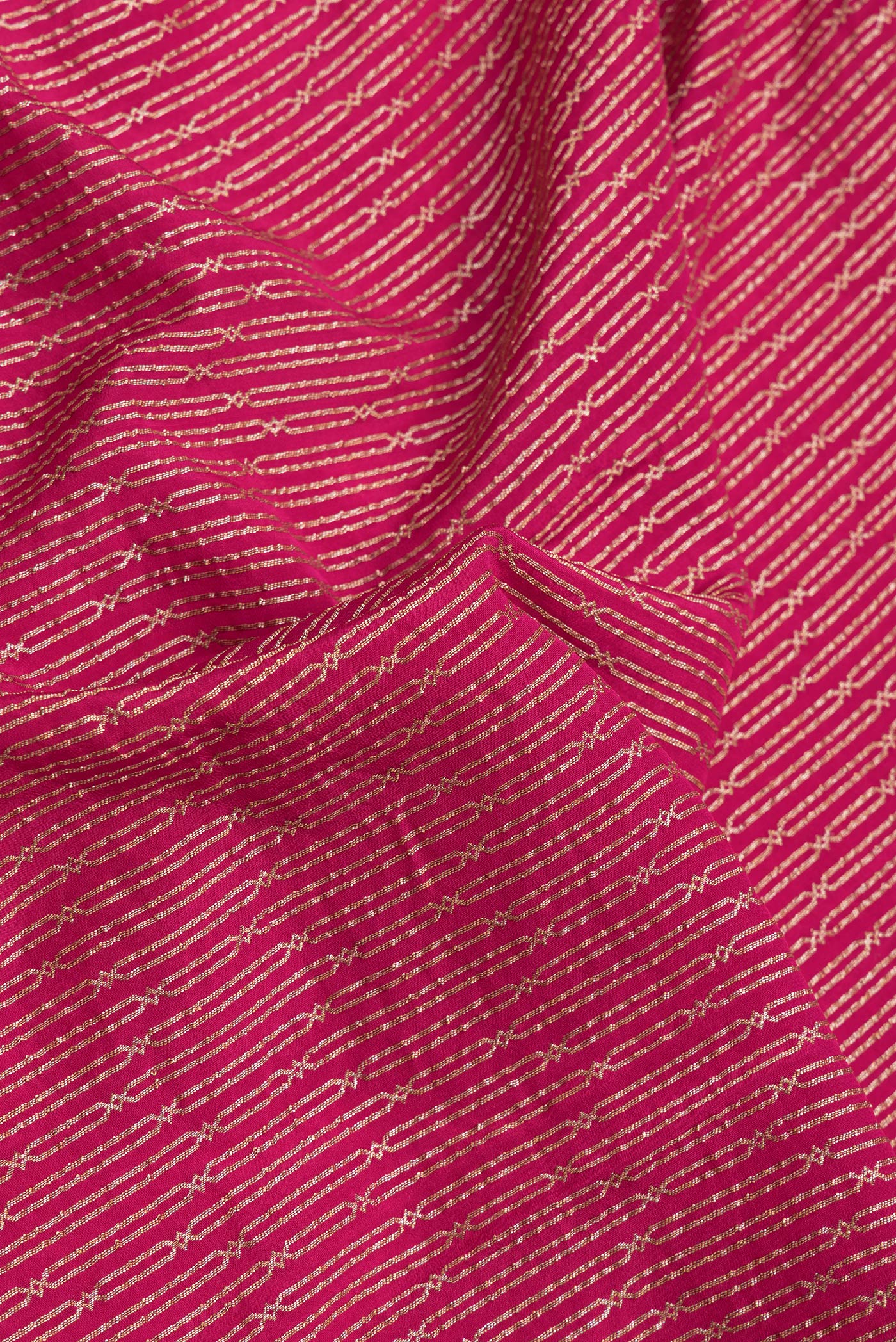 Close up of Dark Pink Dual Tone Banarasi Georgette Saree with Zari Brocade on the body and Zari Border.  displaying folds