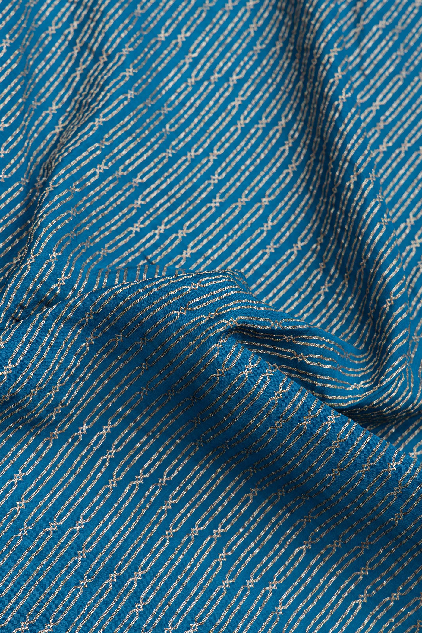 Close up of Peacock Blue Dual Tone Banarasi Georgette Saree with Zari Brocade on the body and Zari Border.  displaying folds