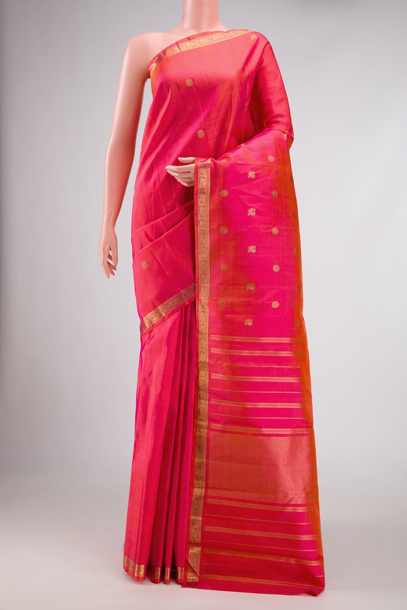 Coral Dual Tone Kanchipuram Silk Saree with Zari Butta on the body and Zari Border.  displayed on a mannequin