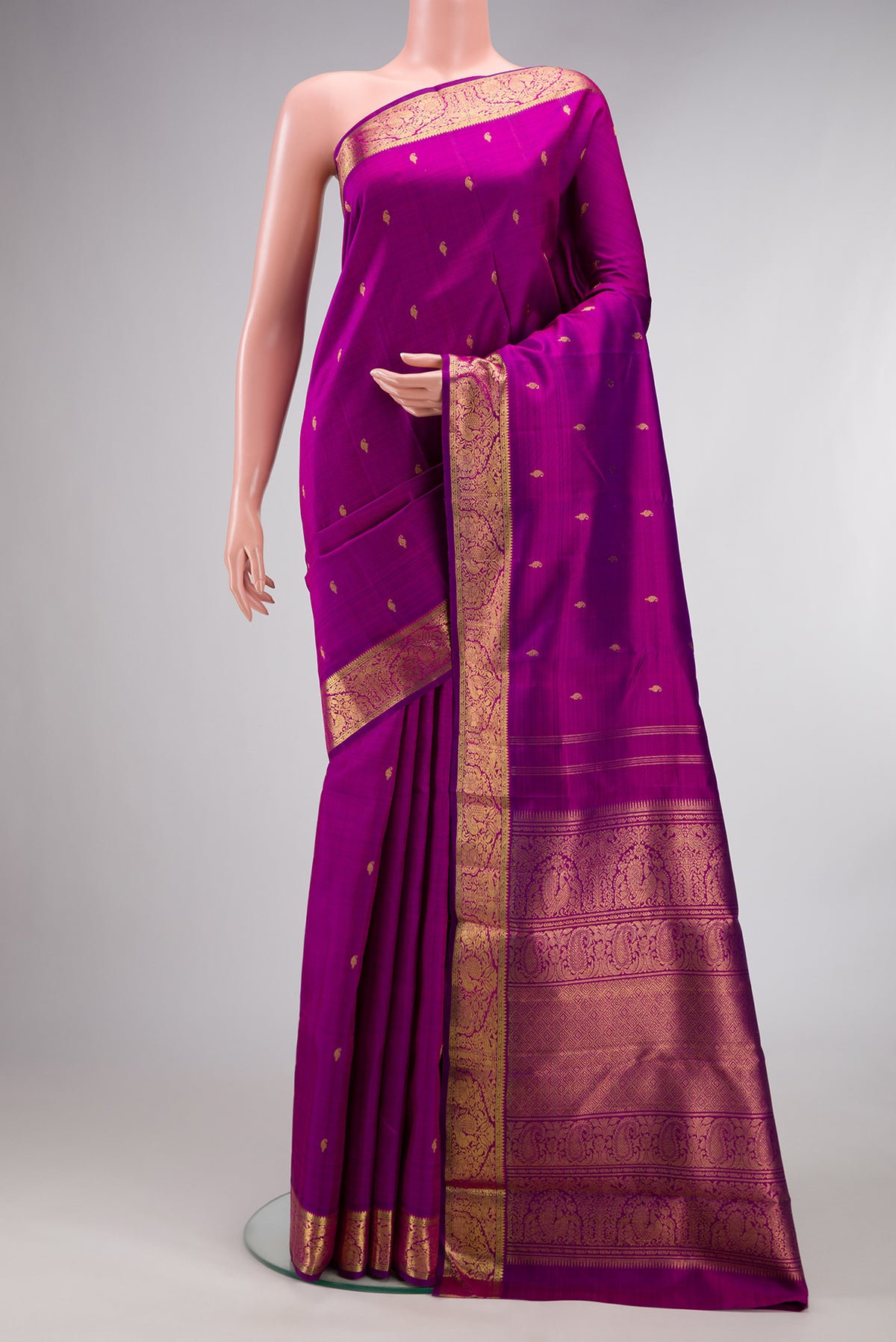 Pure Silk Pure Zari Purple Kanchipuram Saree with Zari Butta on the body and Zari Border.  displayed on a mannequin
