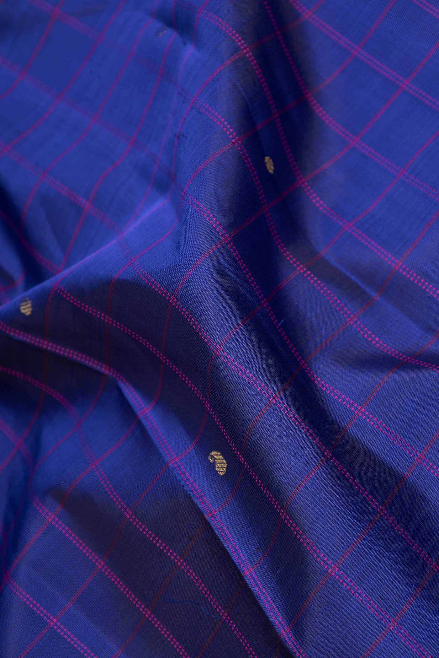 Close up of Royal Blue Dual Tone Kanchipuram Silk Saree with Checked design on the body and Zari Border displaying folds