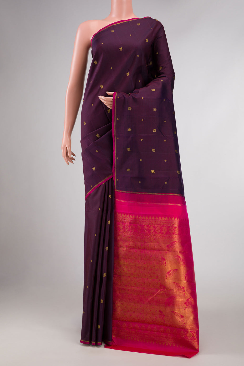 Pure Silk Pure Zari Burgundy Dual Tone Kanchipuram Saree with Zari Butta on the body and Thin Zari Line displayed on a mannequin