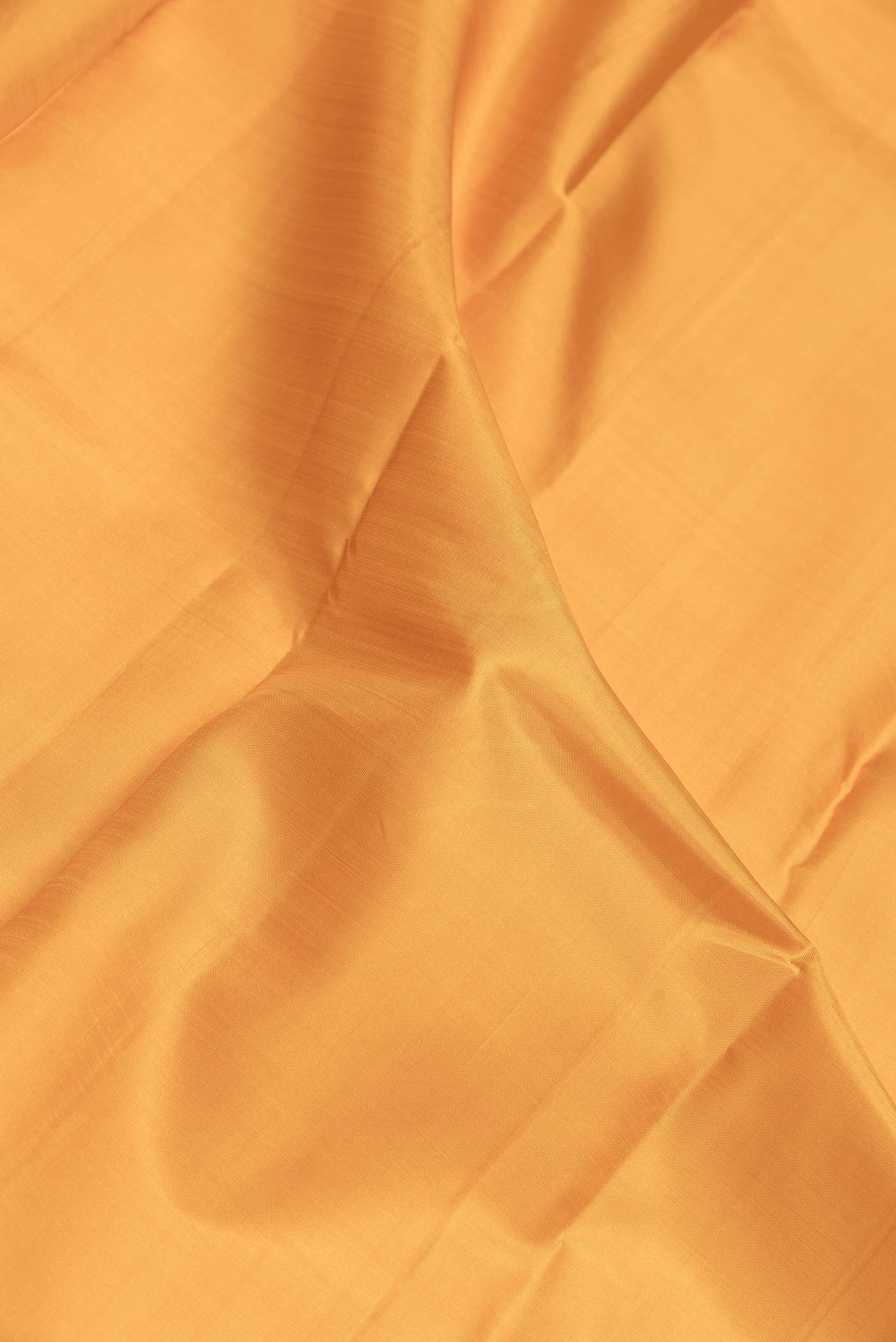 Close up of Maroon Dual Tone Kanchipuram Saree with Plain Body and Zari Border.  displaying folds