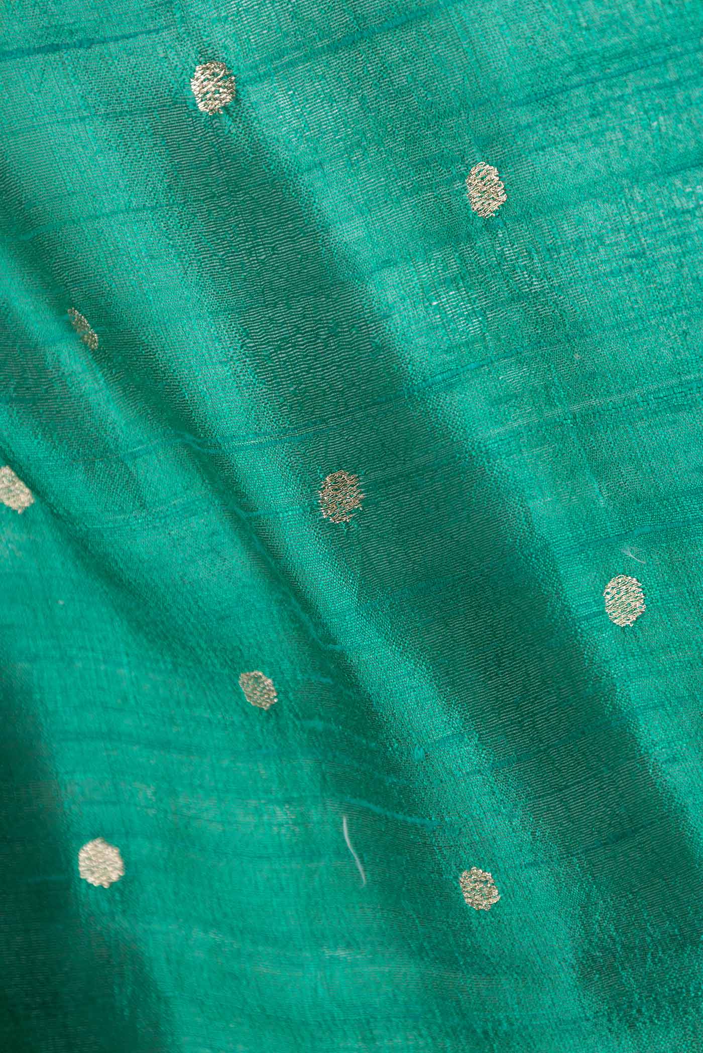 Close up of Green Tussar Silk Saree with Embroidery on the body and Embroidery Border displaying folds