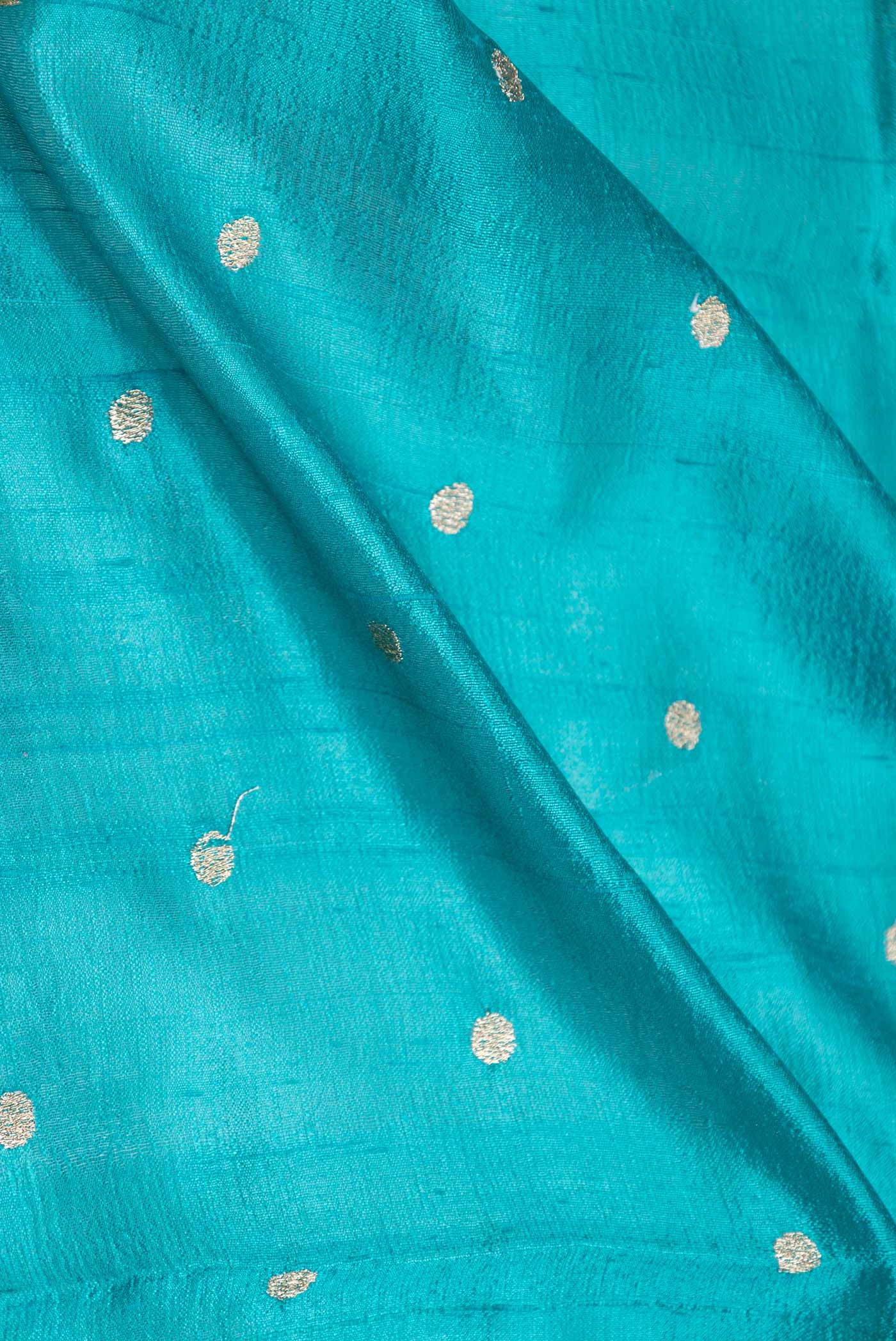 Close up of Blue Tussar Silk Saree with Embroidery on the body and Embroidery Border displaying folds