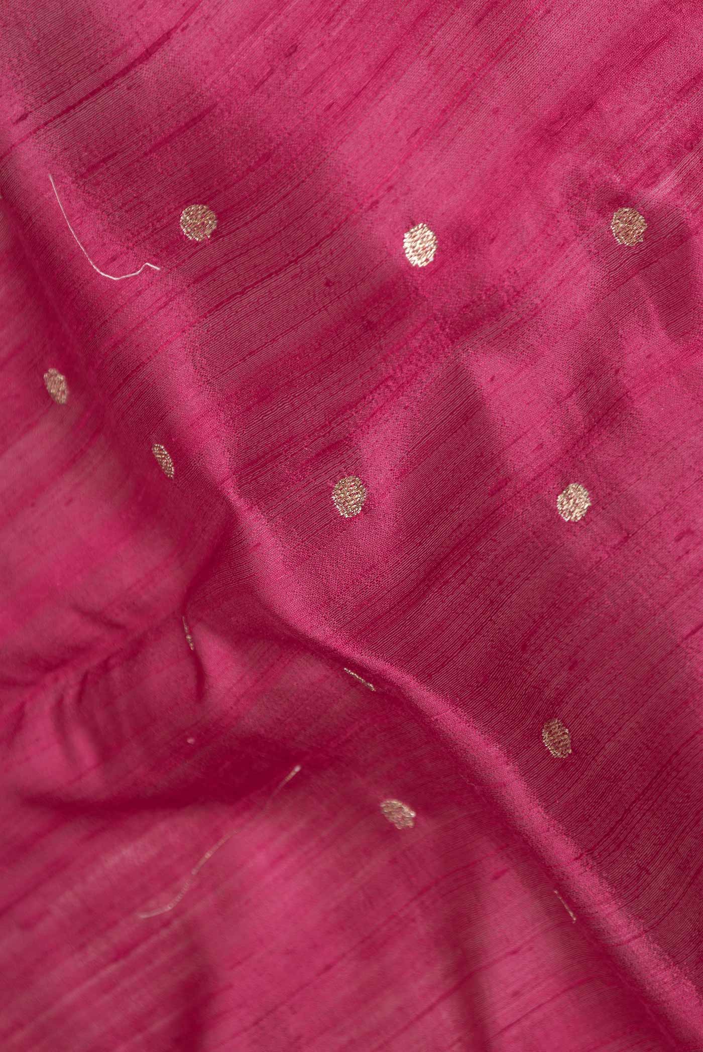Close up of Maroon Dual Tone Tussar Saree with Zari Butta on the body and Embroidery Border displaying folds