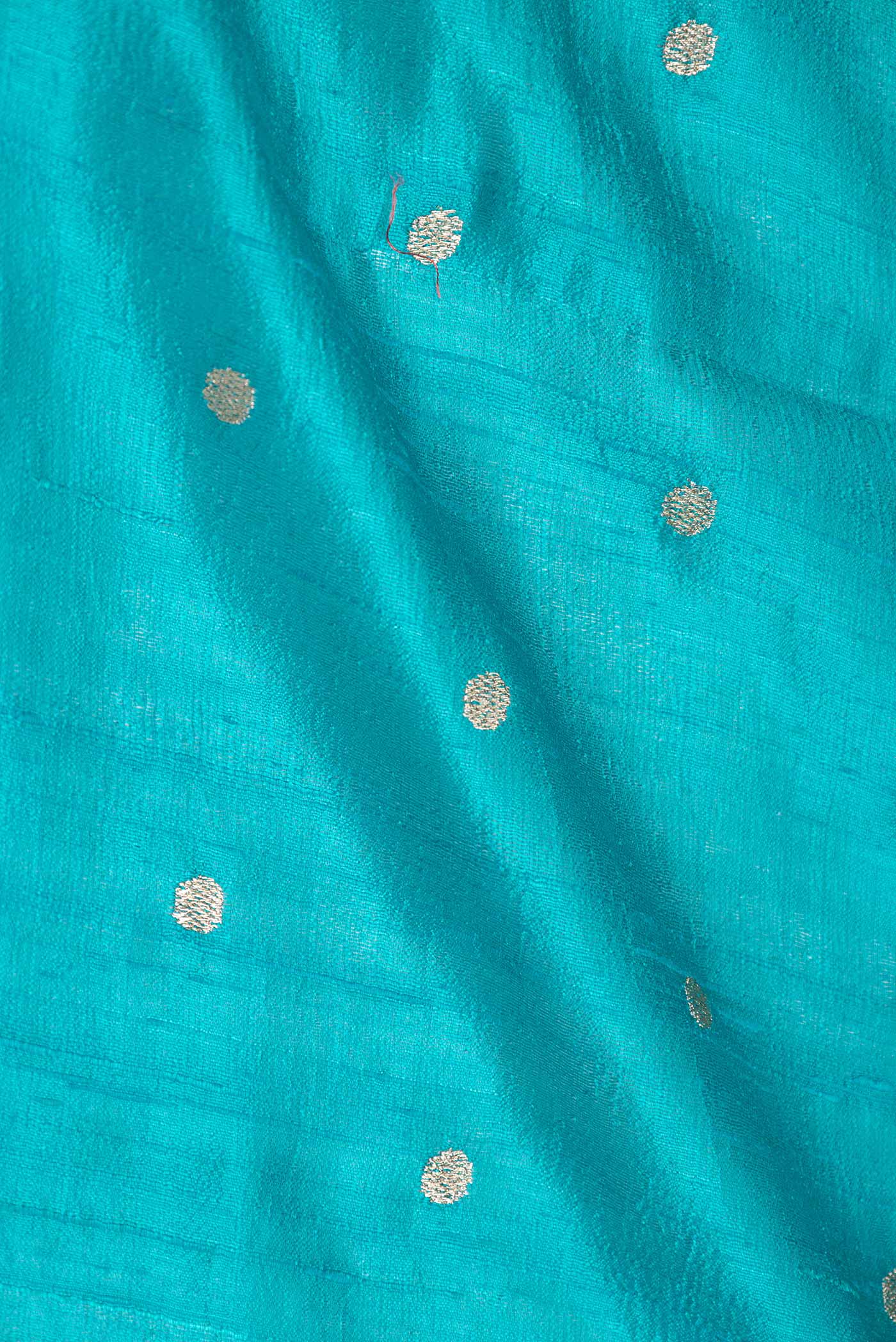 Close up of Sky Blue Dual Tone Tussar Saree with Zari Butta on the body and Embroidery Border displaying folds