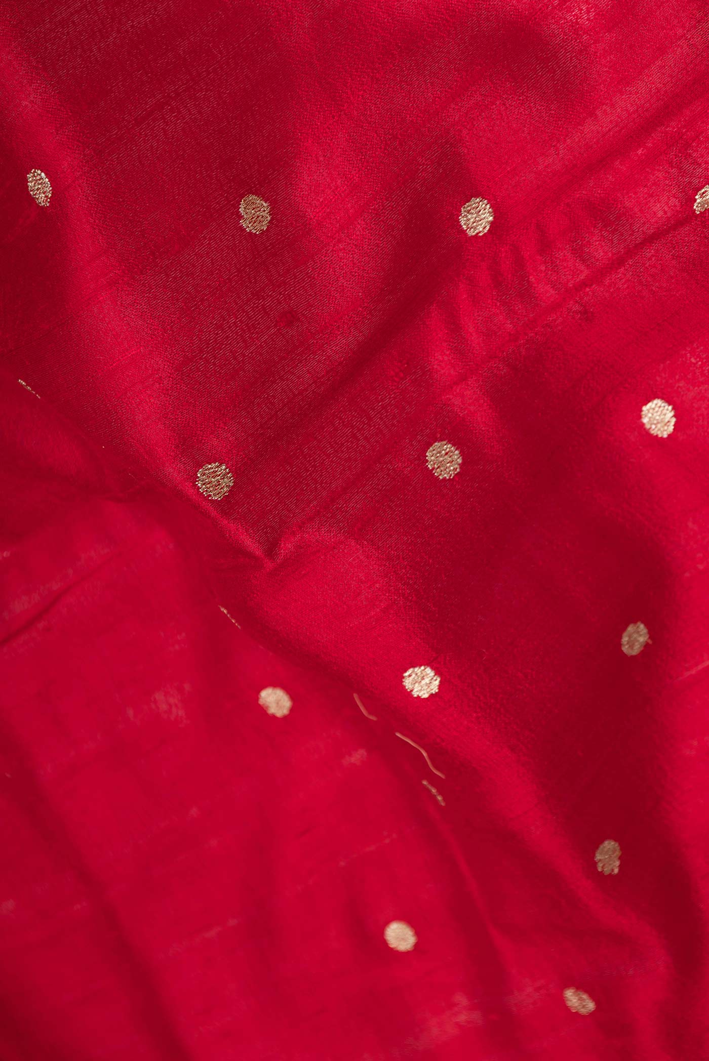 Close up of Red Tussar Silk Saree with Embroidery on the body and Embroidery Border displaying folds