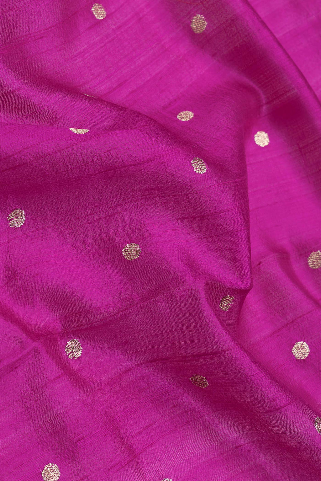 Close up of Magenta Dual Tone Tussar Silk Saree with Zari Butta on the body and Embroidery Border.  displaying folds
