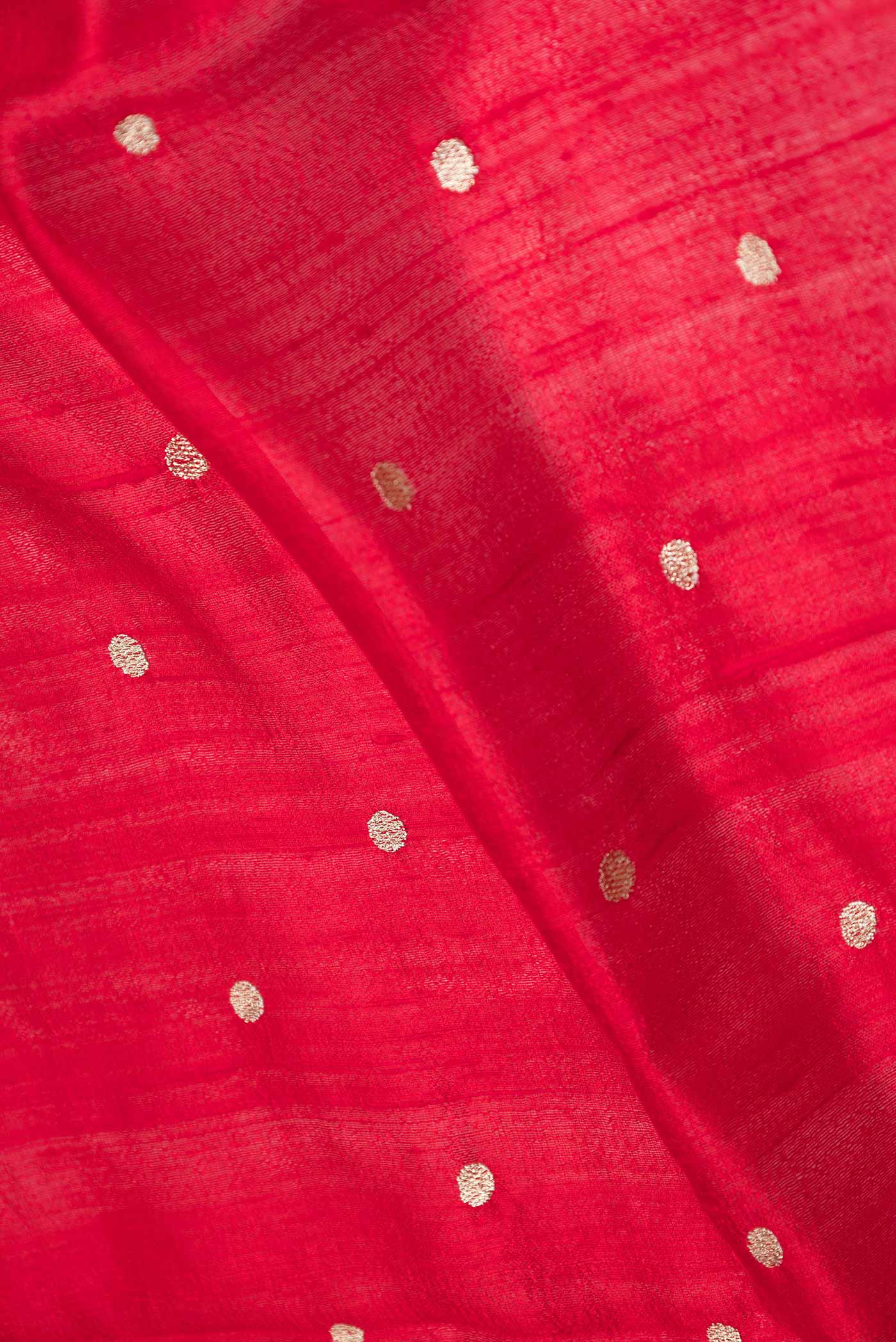 Close up of Red Dual Tone Tussar Saree with Zari Butta on the body and Embroidery Border displaying folds