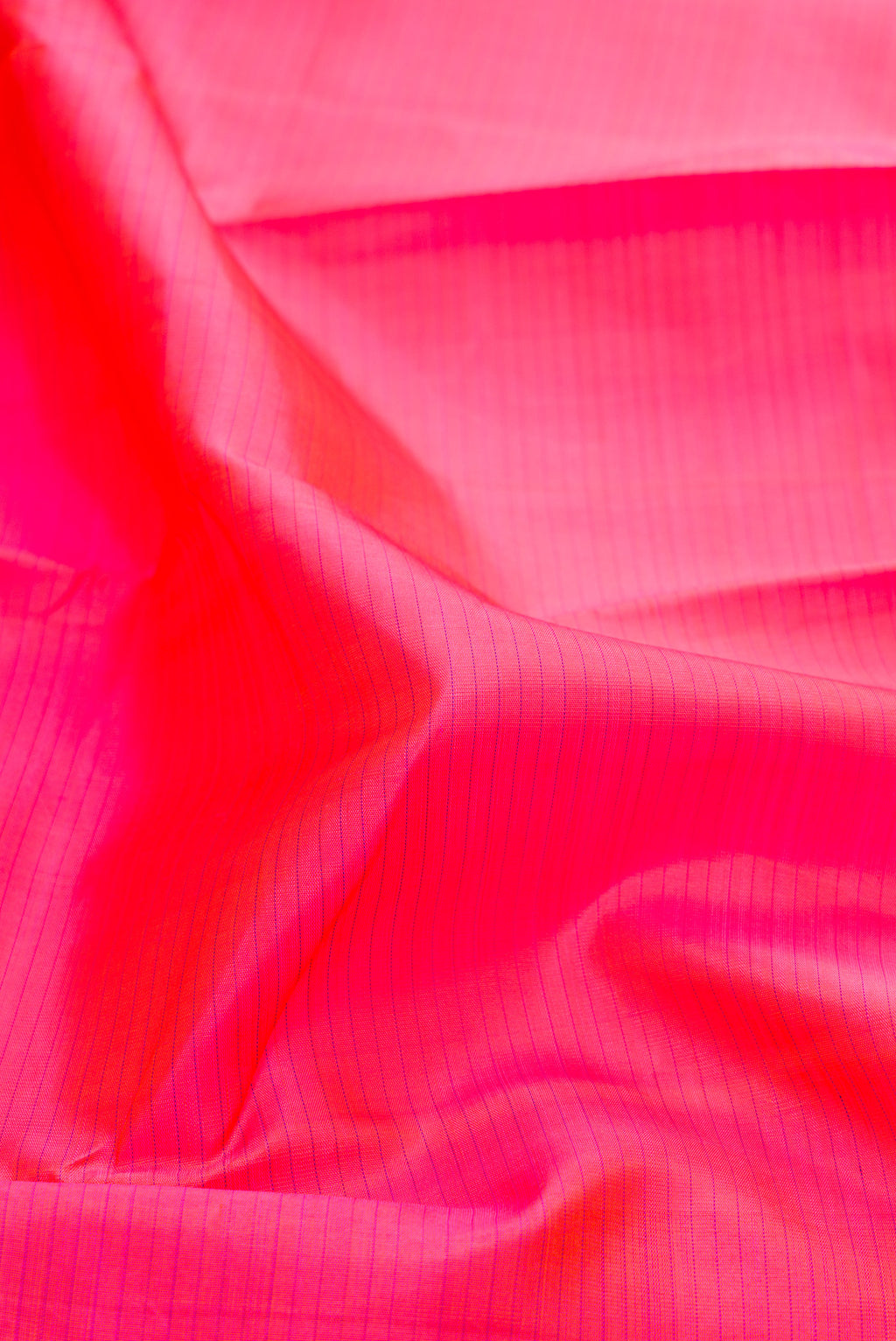 Close up of Pink Kanjivaram Silk Saree with Stripes on the body and Zari Border.  displaying folds
