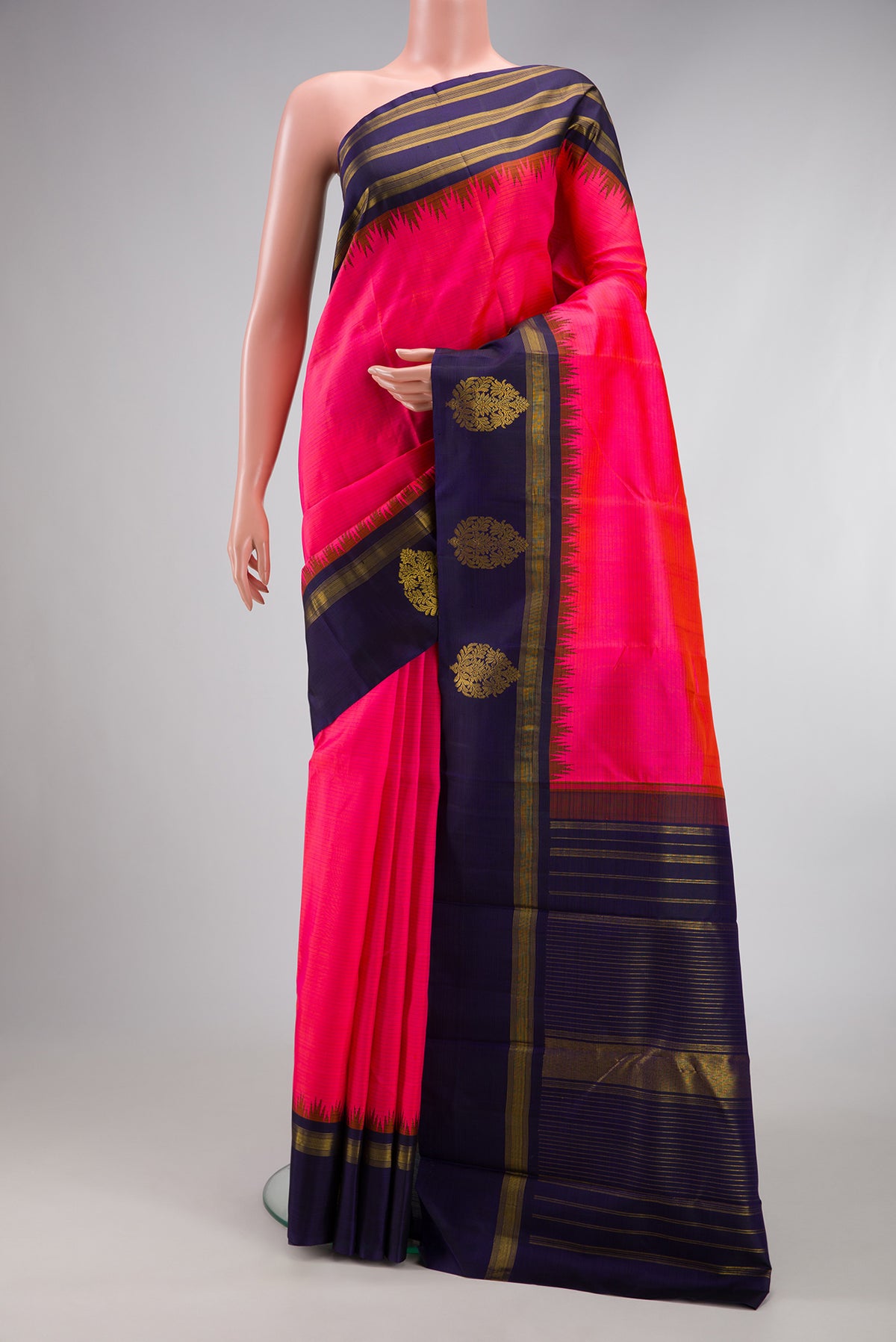 Pink Kanjivaram Silk Saree with Stripes on the body and Zari Border.  displayed on a mannequin