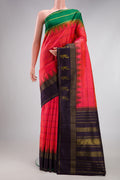 Coral Dual Tone Kanjivaram Silk Saree with Stripes on the body and Ganga Jamuna Border.  displayed on a mannequin