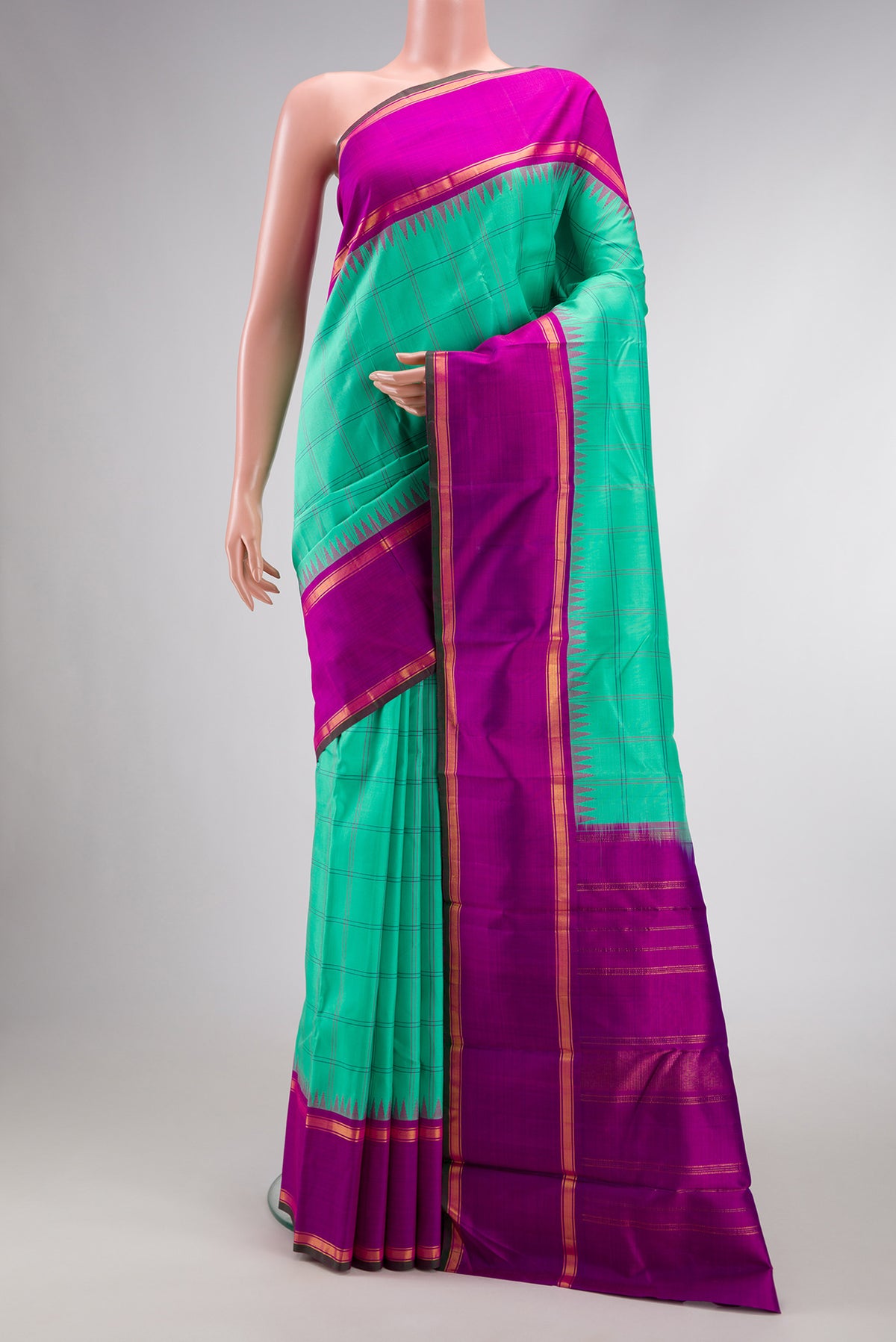 Pure Silk Pure Zari Sea Green Dual Tone Kanjivaram Saree with Checked design on the body and Zari And Thread Border.  displayed on a mannequin
