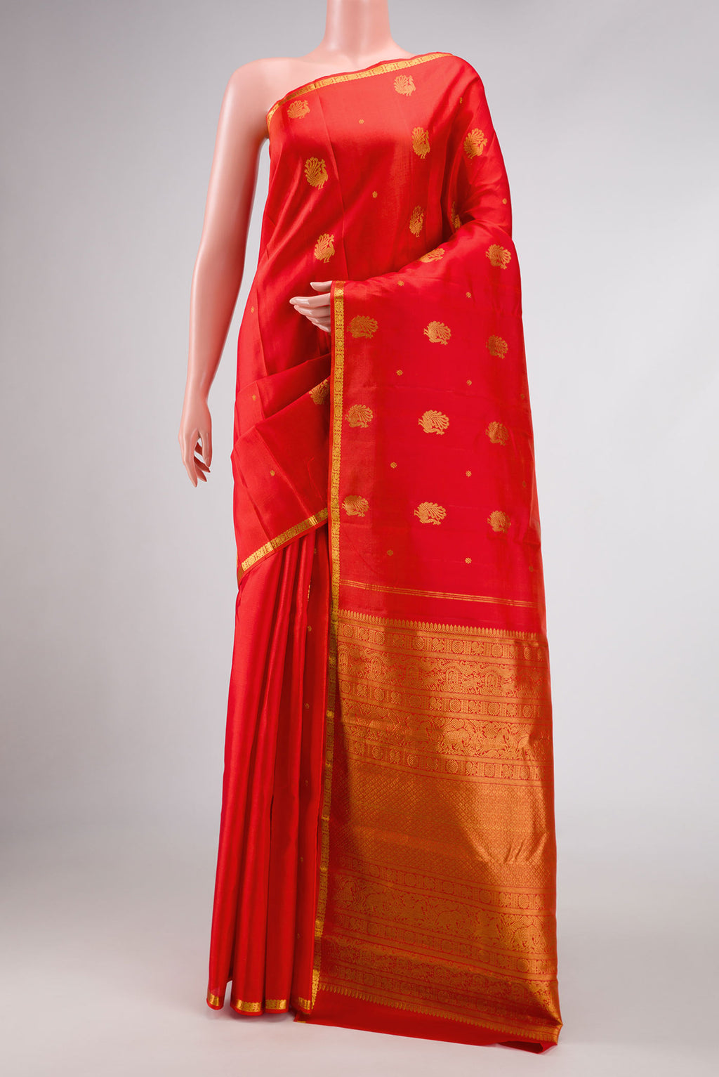 Orange Dual Tone Kanjivaram Silk Saree with Zari Butta on the body and Zari Border.  displayed on a mannequin
