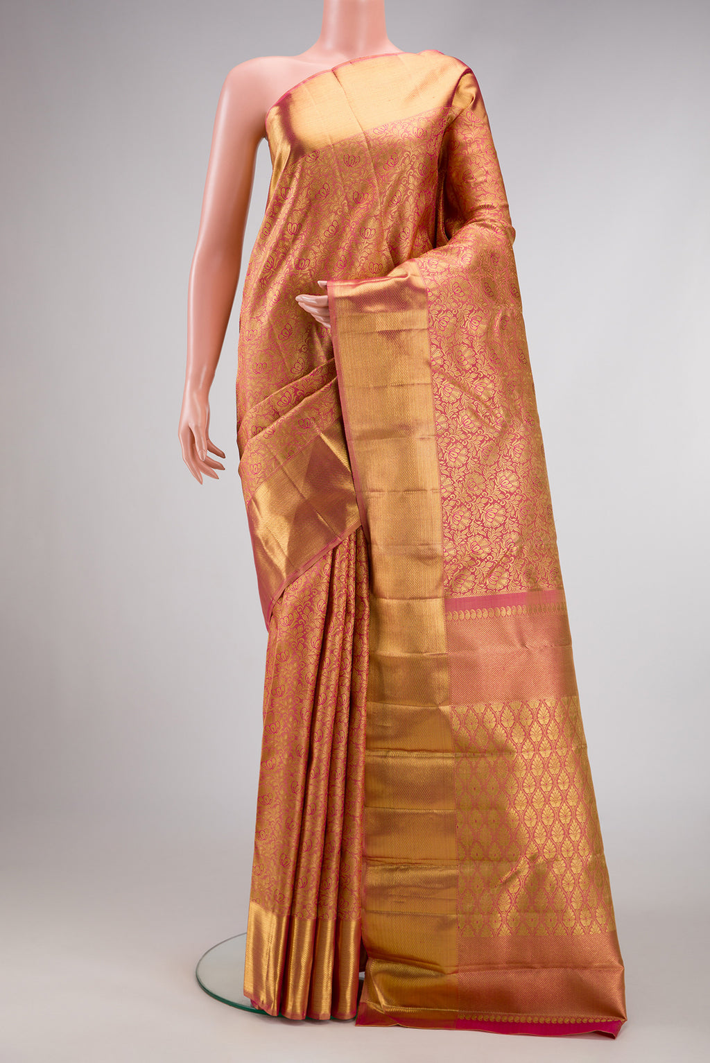 Pure Silk Pure Zari Rose Gold Dual Tone Kanjivaram Saree with Zari Brocade on the body and Zari Border.  displayed on a mannequin