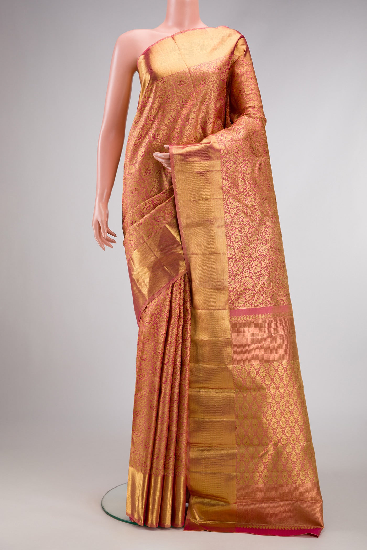 Pure Silk Pure Zari Rose Gold Dual Tone Kanjivaram Saree with Zari Brocade on the body and Zari Border.  displayed on a mannequin