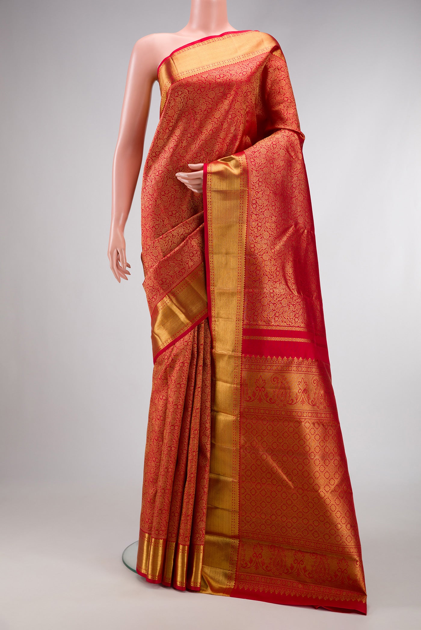 Pure Silk Pure Zari Red Dual Tone Kanjivaram Saree with Zari Brocade on the body and Zari Border.  displayed on a mannequin