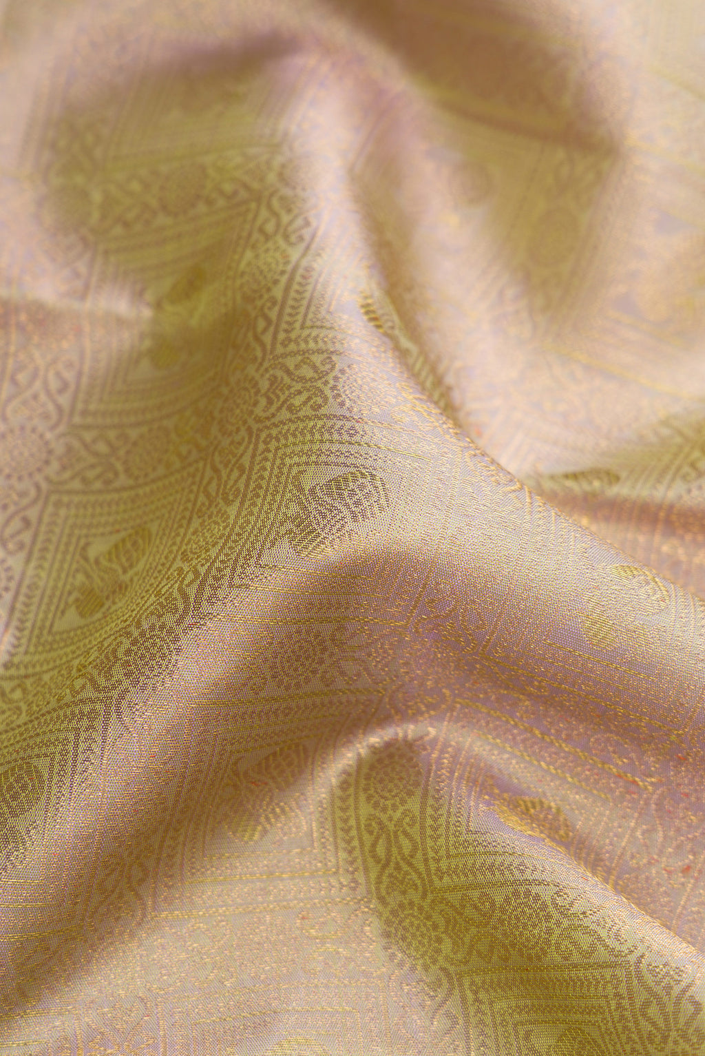 Close up of Pure Silk Pure Zari Light Green Dual Tone Kanjivaram Saree with Zari Brocade on the body and Zari Border.  displaying folds