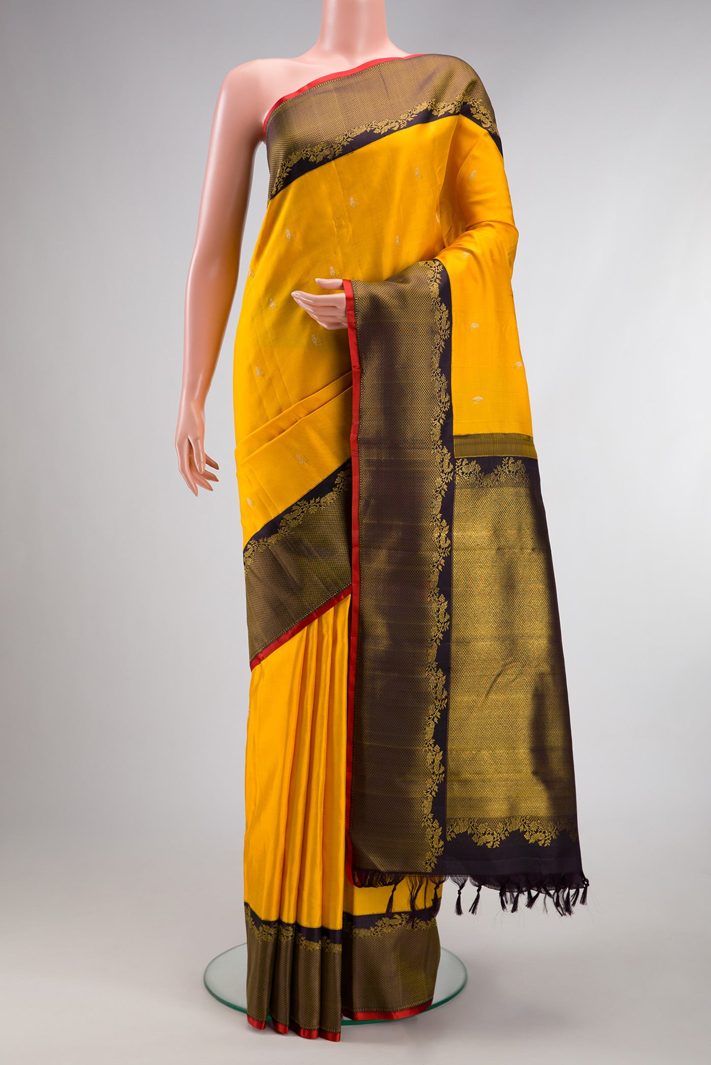 Pure Silk Pure Zari Yellow Kanjivaram Saree with Zari Butta on the body and Zari Border.  displayed on a mannequin