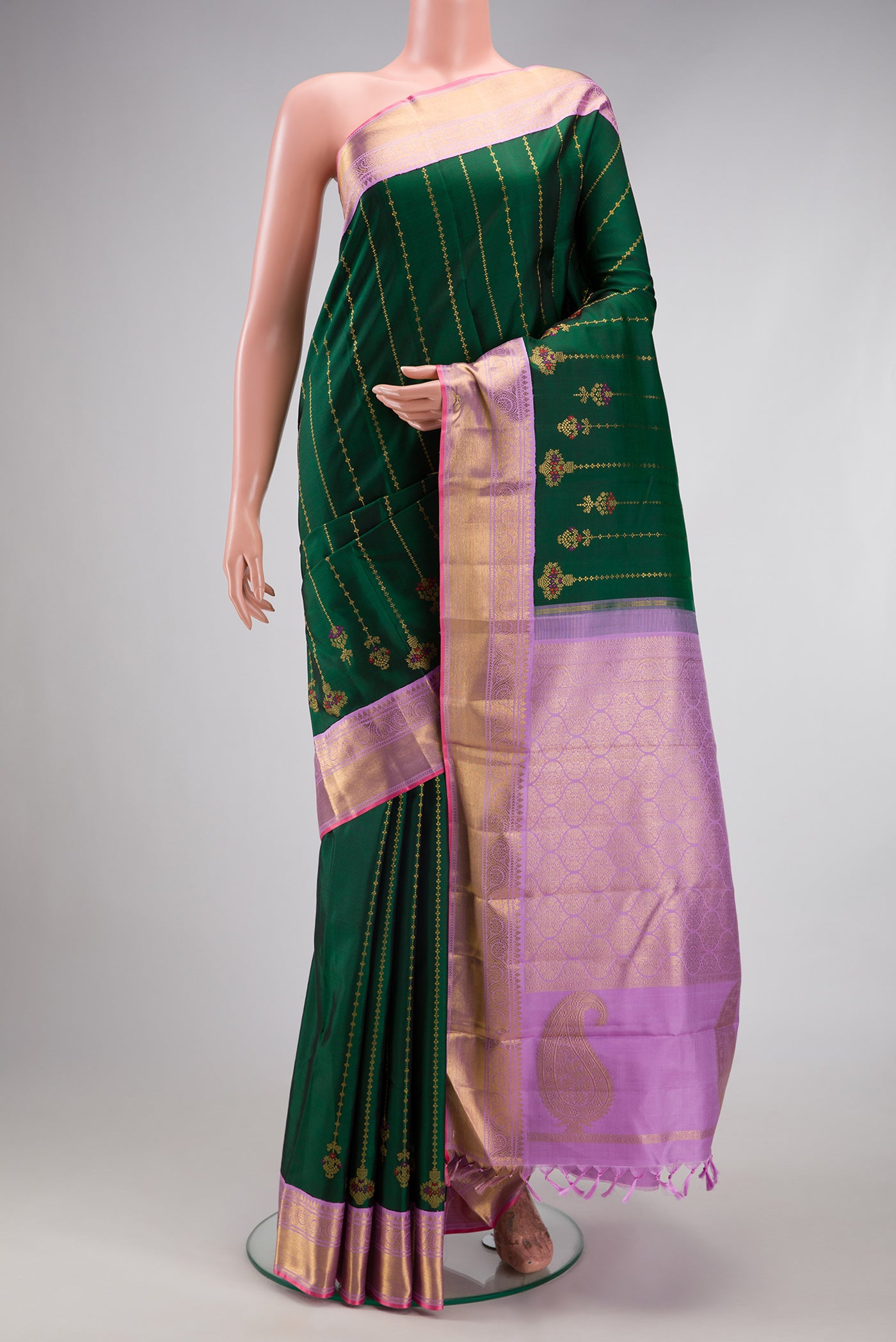 Pure Silk Pure Zari Bottle Green Kanjivaram Saree with Stripes on the body and Zari Border.  displayed on a mannequin