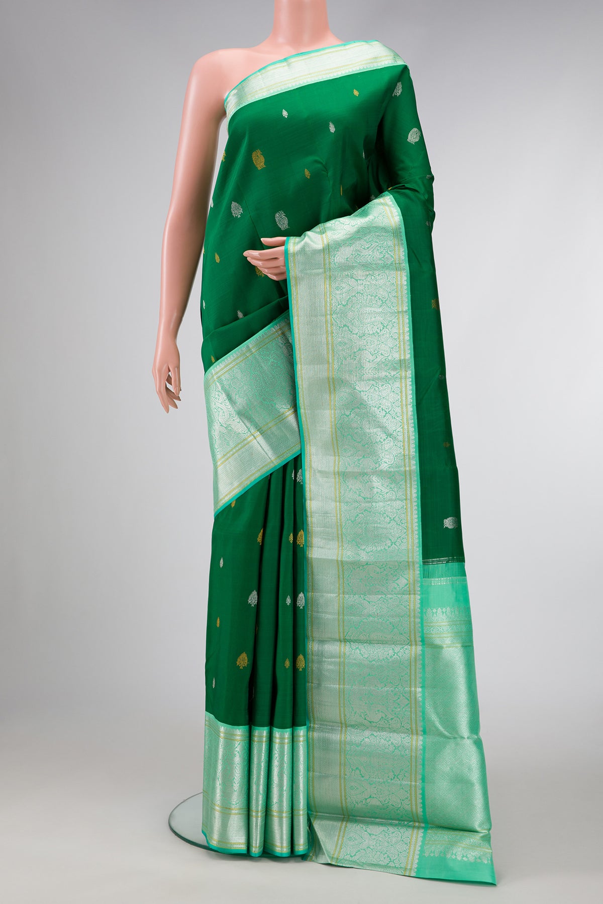 Pure Silk Pure Zari Green Dual Tone Kanchipuram Saree with Zari Butta on the body and Zari Border.  displayed on a mannequin