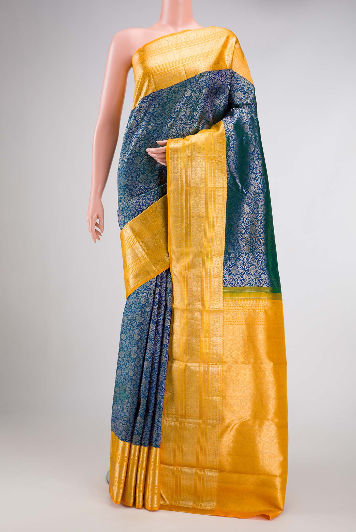 Peacock Blue Dual Tone Kanchipuram Silk Saree with Zari Brocade on the body and Zari Border.  displayed on a mannequin