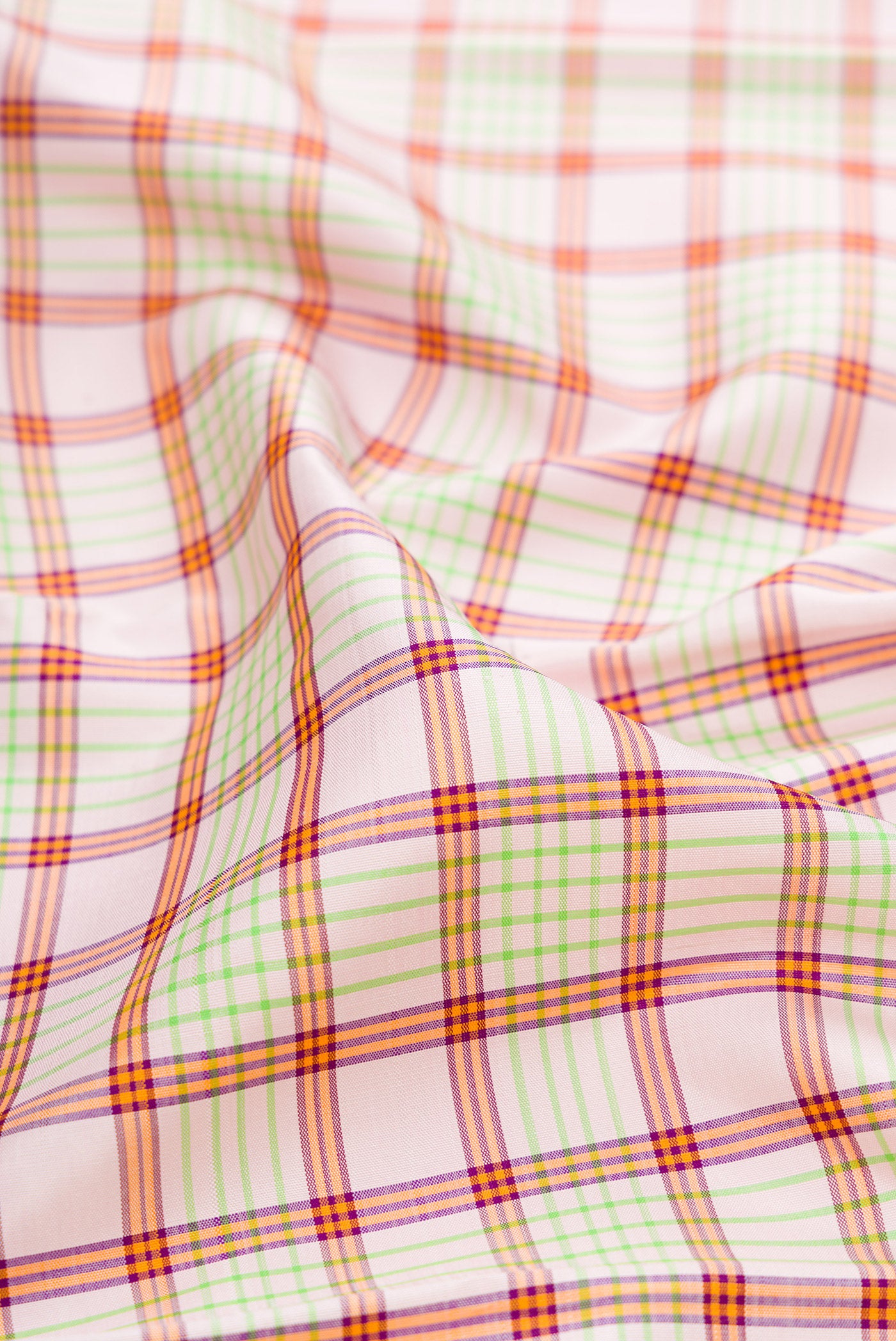 Close up of Pink Kanchipuram Silk Saree with Checked design on the body and Zari Border.  displaying folds