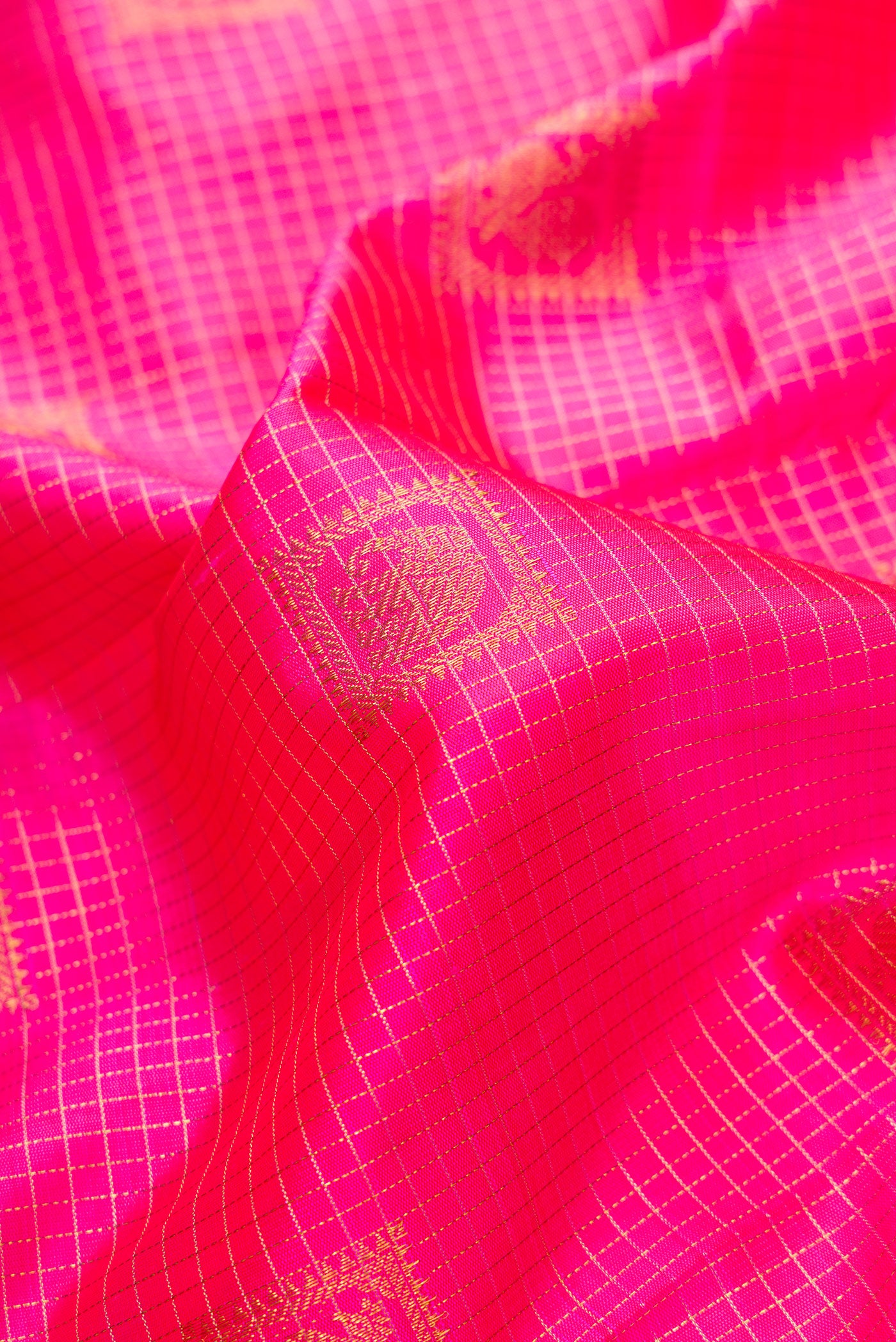 Close up of Pink Dual Tone Kanchipuram Silk Saree with Checked design on the body and Zari Border.  displaying folds