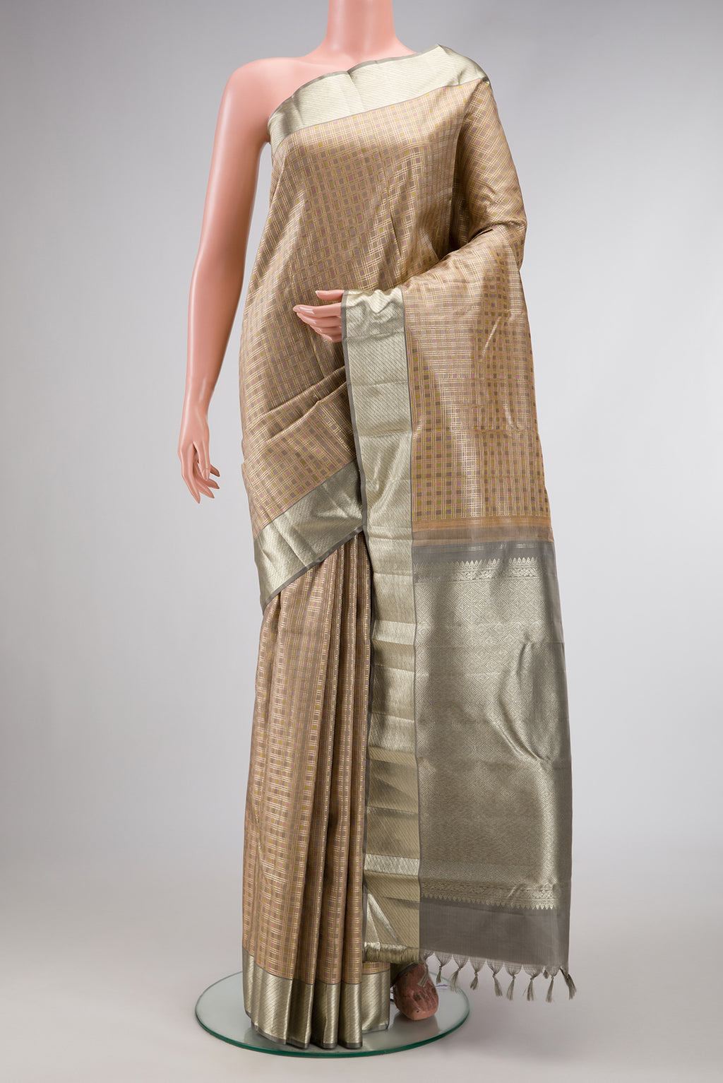 Gold Dual Tone Kanjivaram Silk Saree with Checked design on the body and Zari Border.  displayed on a mannequin