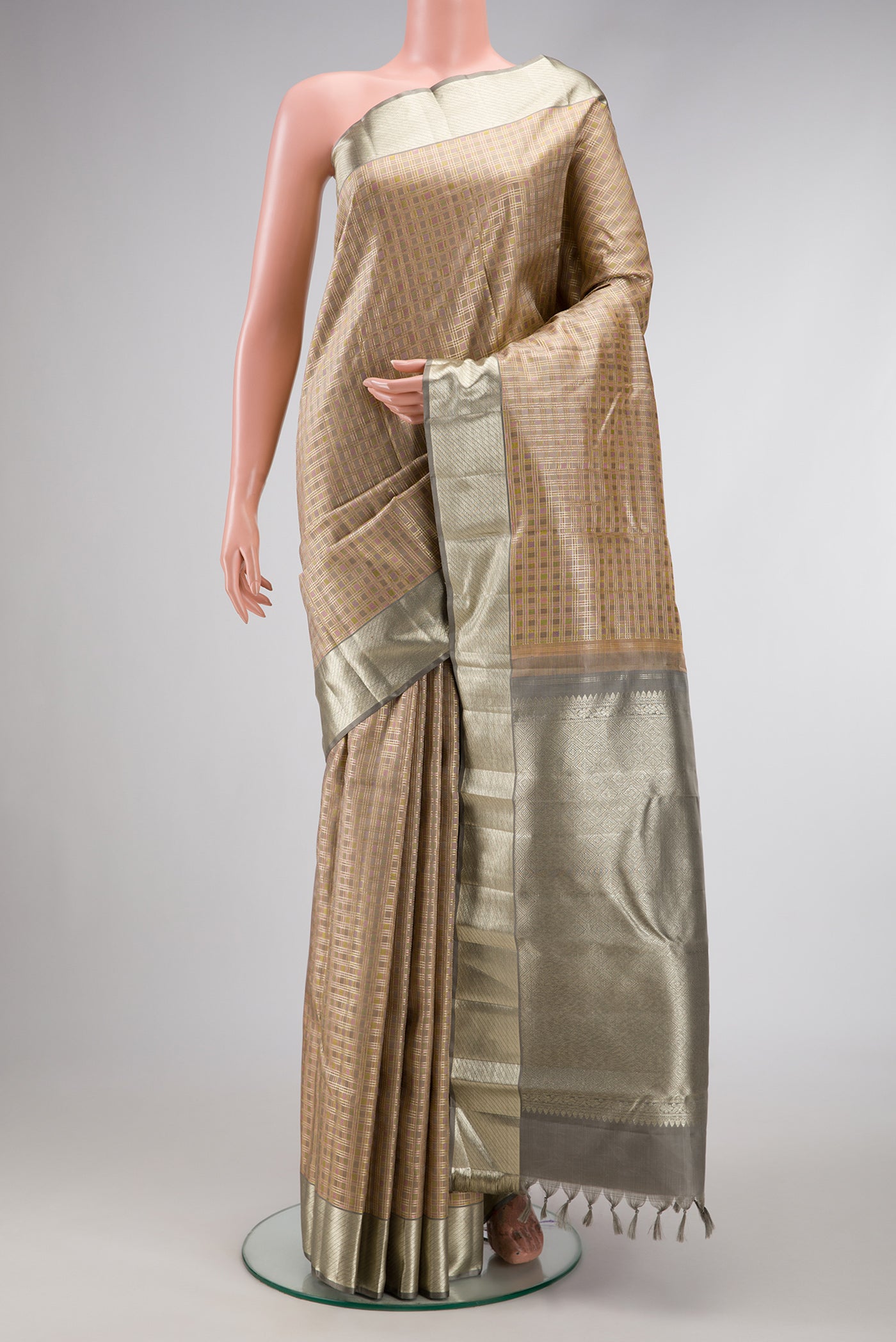 Gold Dual Tone Kanjivaram Silk Saree with Checked design on the body and Zari Border.  displayed on a mannequin