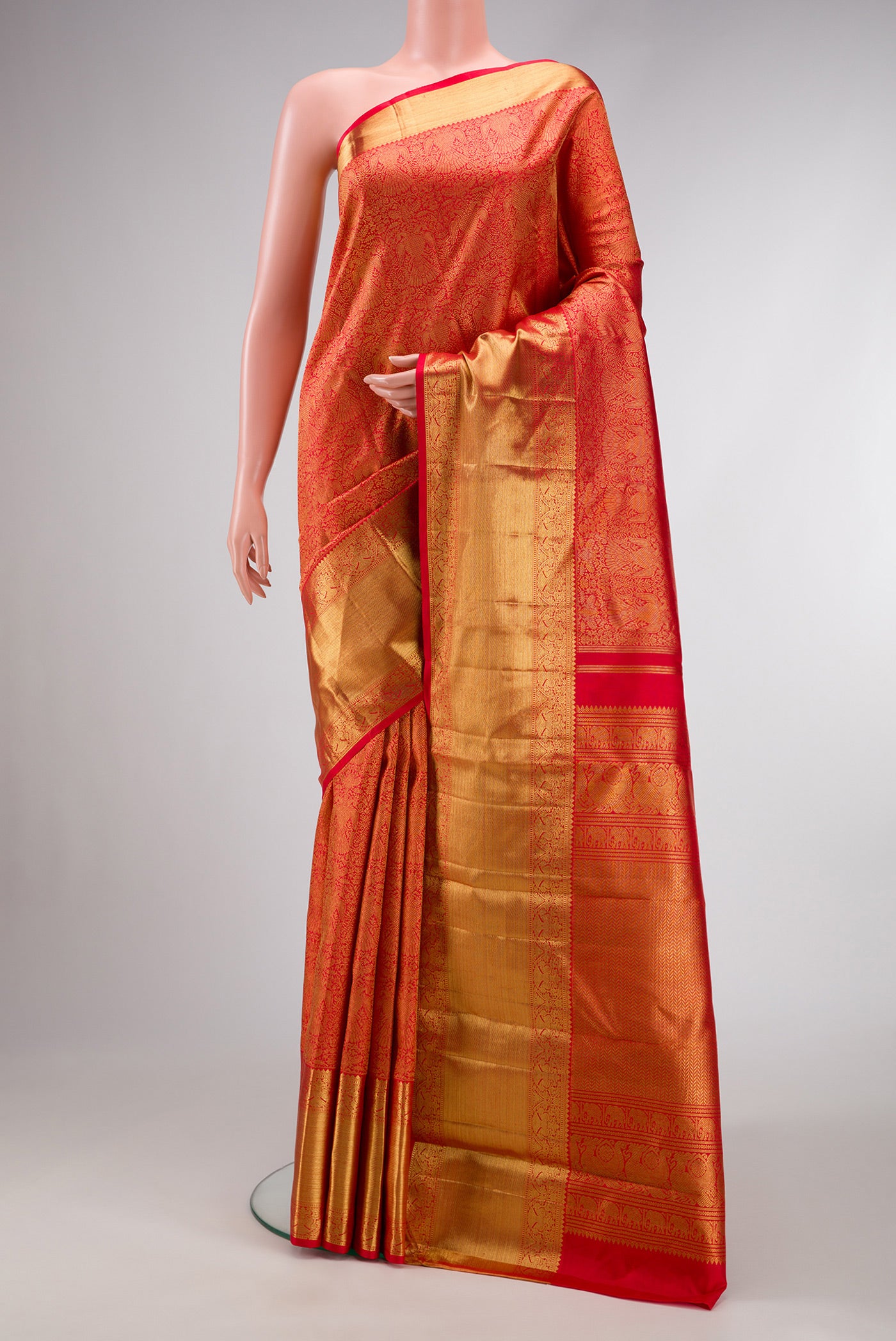Pure Silk Pure Zari Red Dual Tone Kanjivaram Saree with Zari Brocade on the body and Zari Border.  displayed on a mannequin