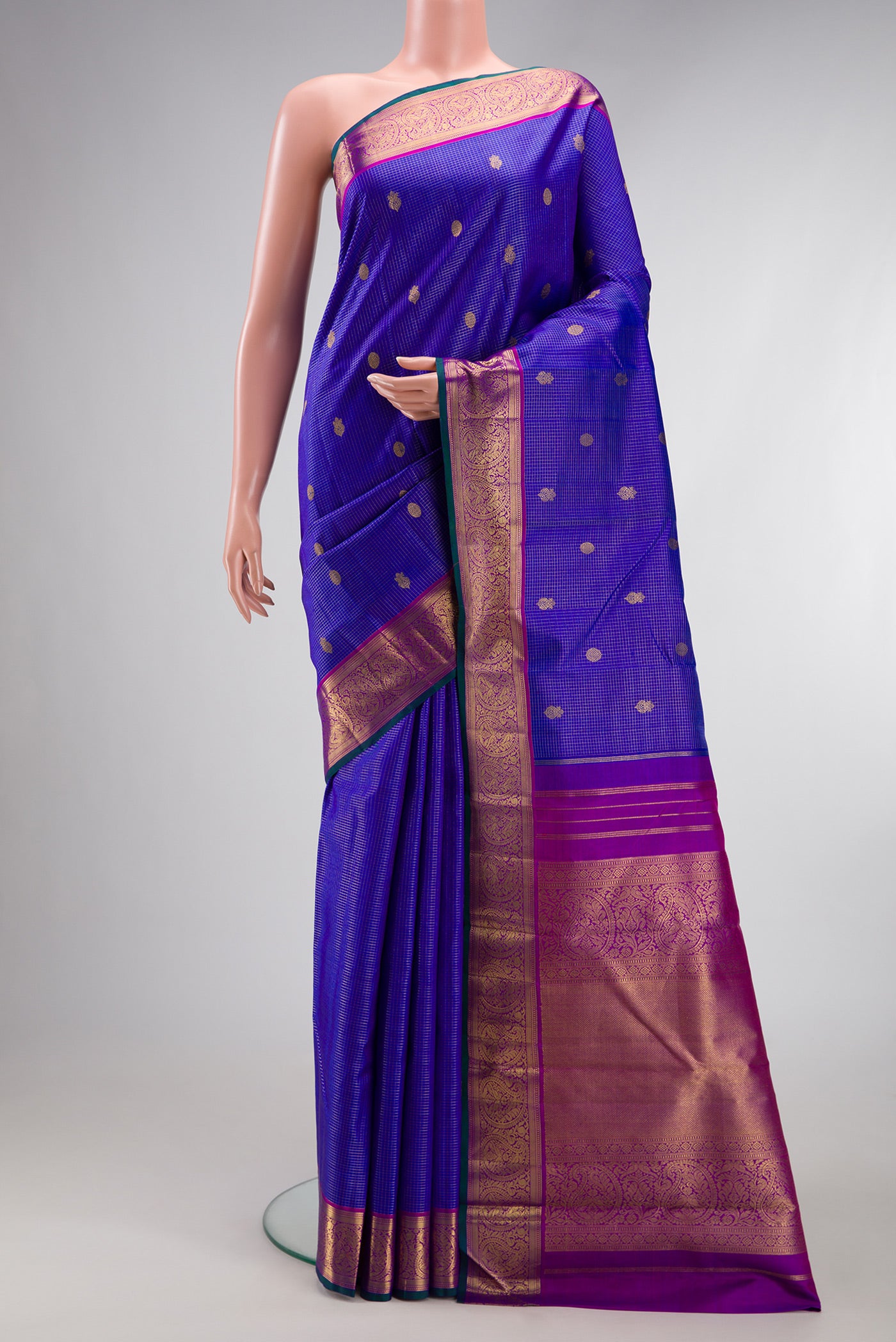 Pure Silk Pure Zari Royal Blue Kanjivaram Saree with Checked design on the body and Zari Border.  displayed on a mannequin