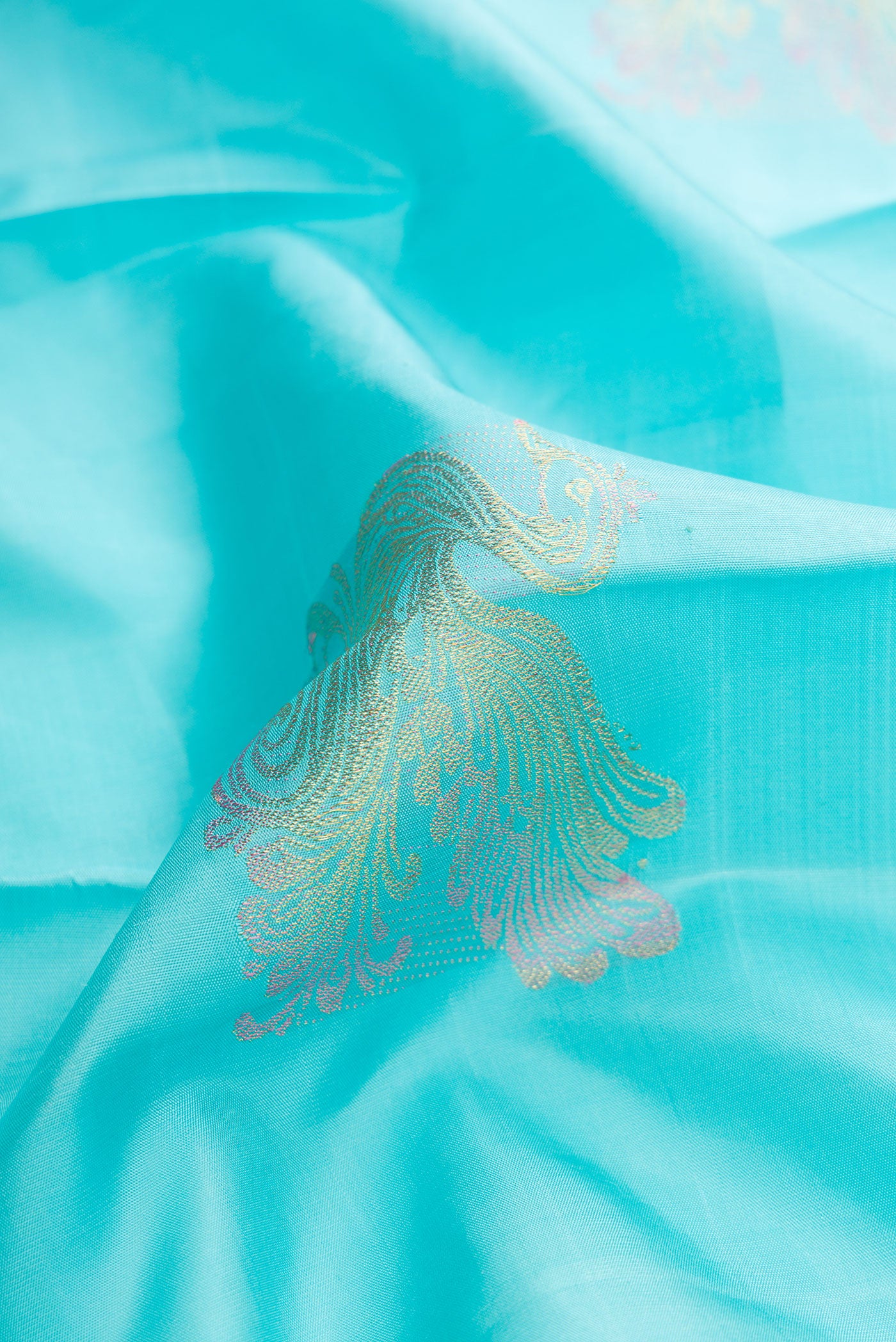 Close up of Pure Silk Pure Zari Sky Blue Dual Tone Kanjivaram Saree with Zari Butta on the body and Without Border.  displaying folds