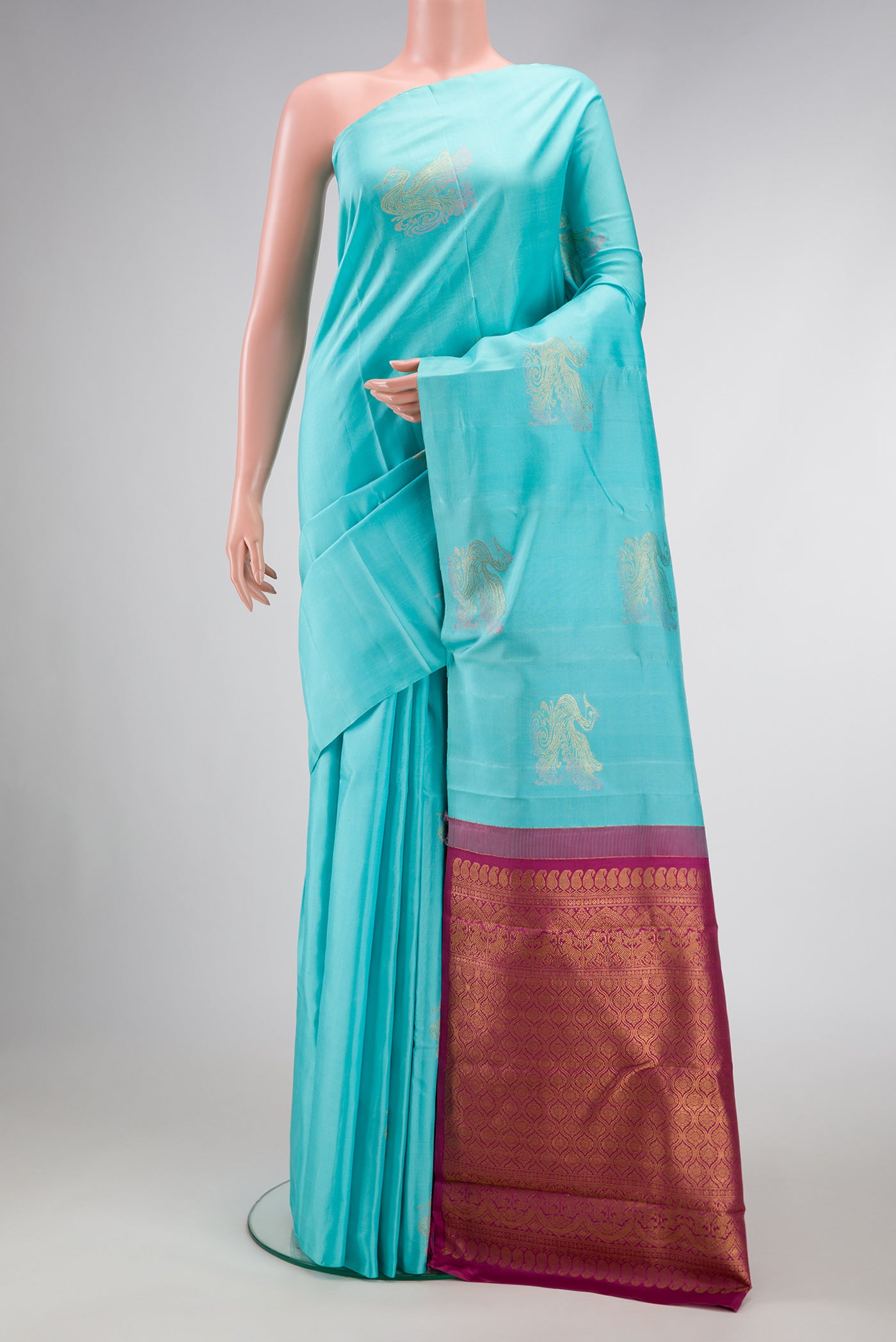 Pure Silk Pure Zari Sky Blue Dual Tone Kanjivaram Saree with Zari Butta on the body and Without Border.  displayed on a mannequin