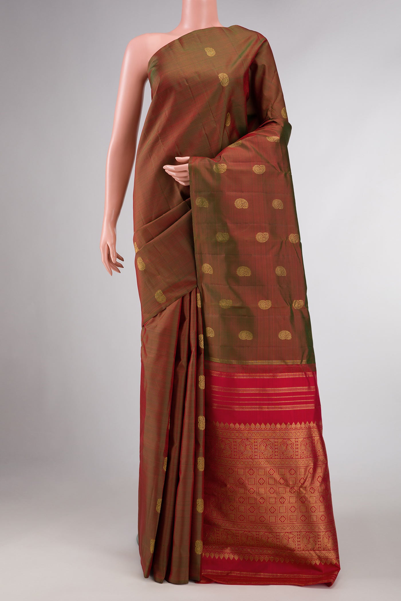 Mehandi Green Dual Tone Kanchipuram Silk Saree with Zari Butta on the body and Without Border displayed on a mannequin