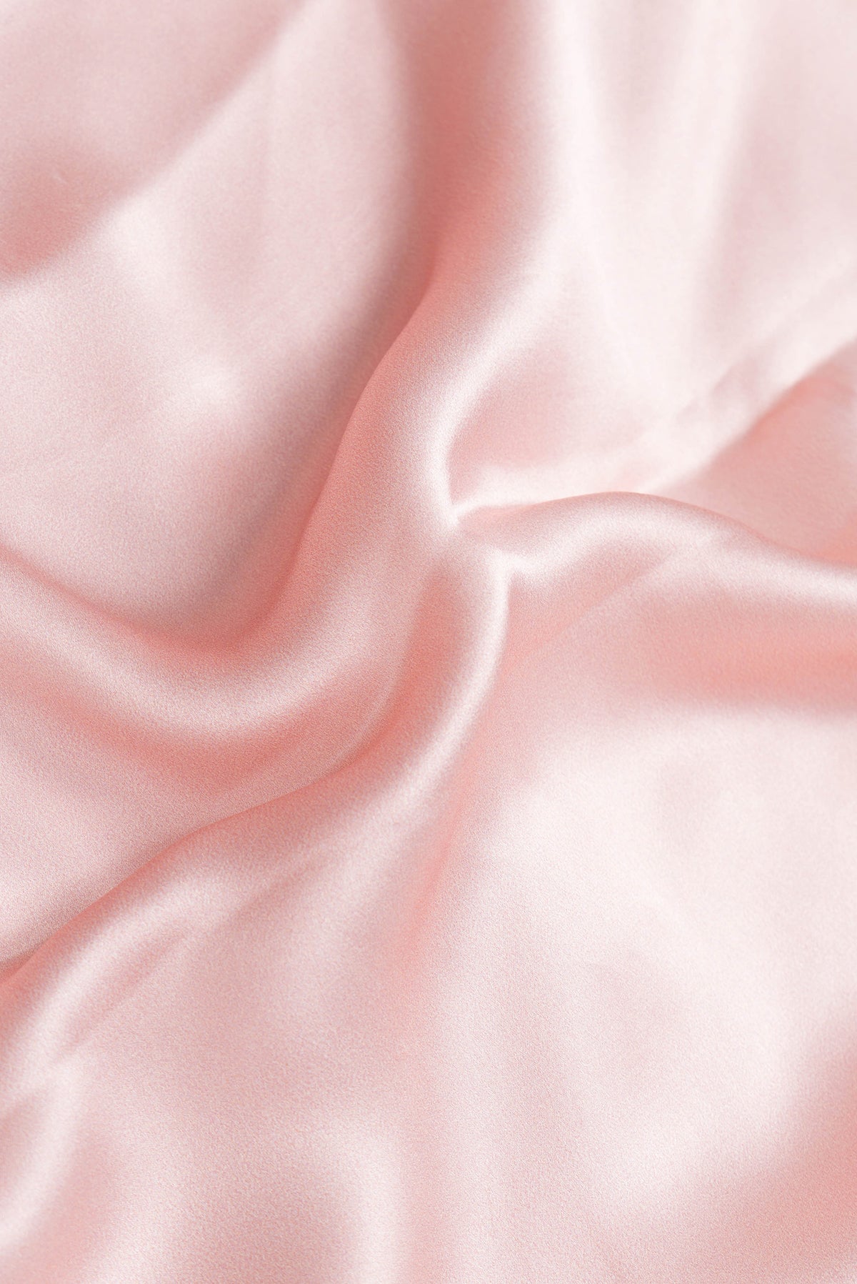 Close up of Rose Gold Dual Tone Mysore Crepe Saree with Printed design on the body and Without Border.  displaying folds