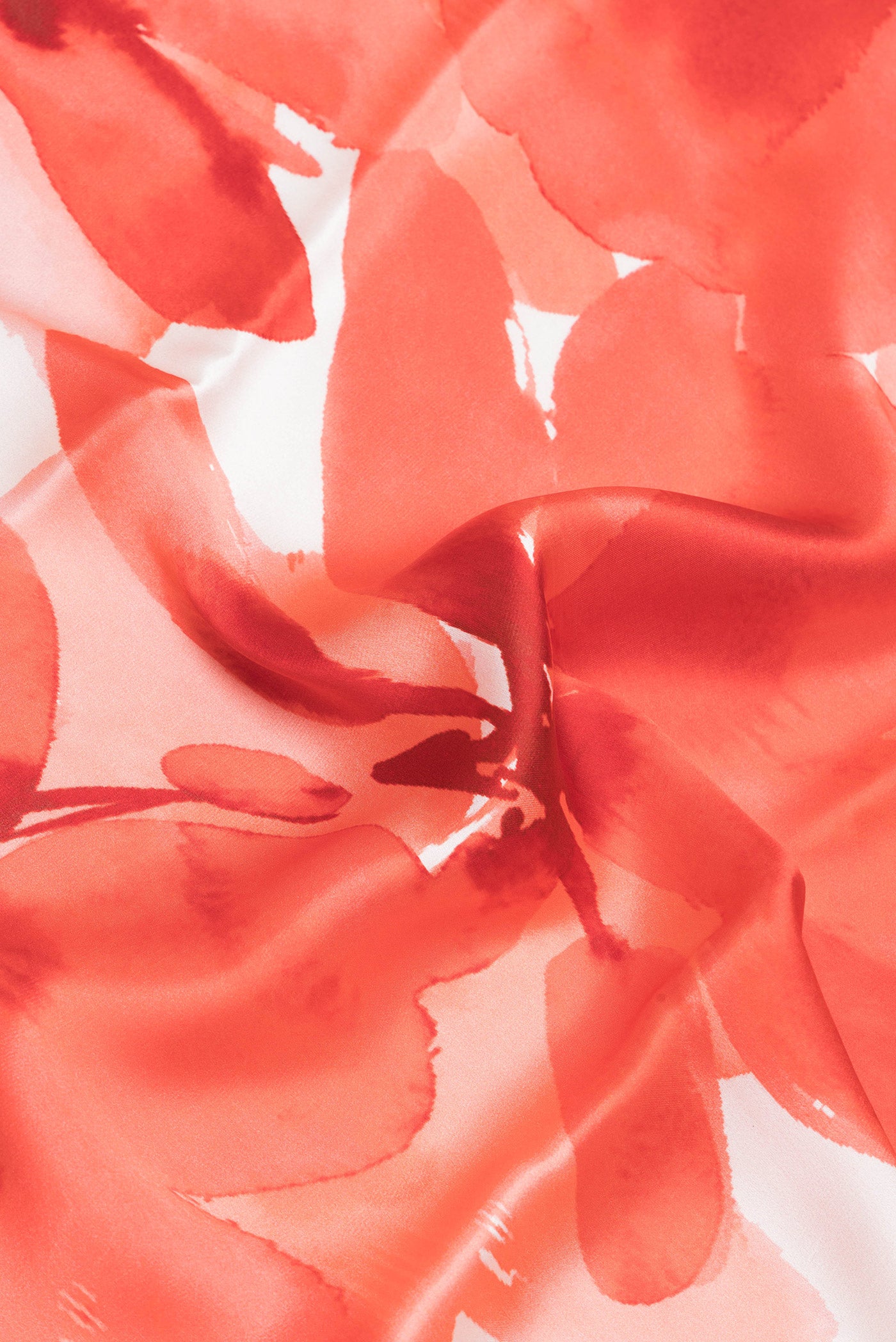 Close up of Orange Crepe Saree with Printed design on the body and Without Border.  displaying folds