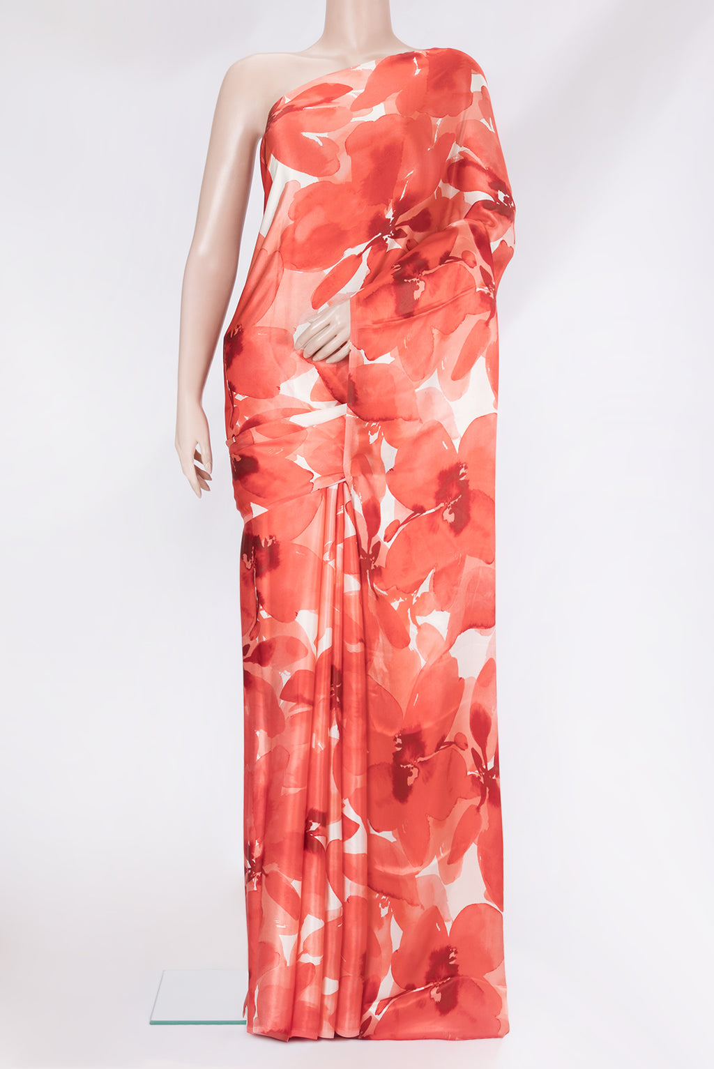 Orange Crepe Saree with Printed design on the body and Without Border.  displayed on a mannequin