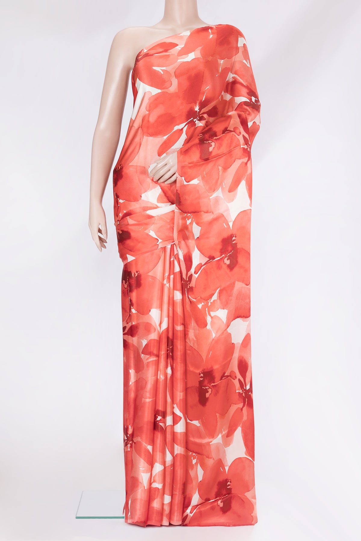Orange Crepe Saree with Printed design on the body and Without Border.  displayed on a mannequin