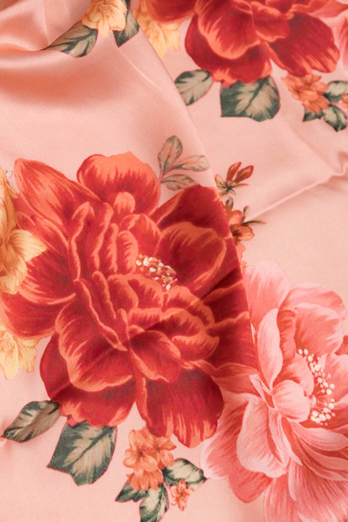 Close up of Peach Satin Silk Saree with Floral Print on the body and Without Border displaying folds