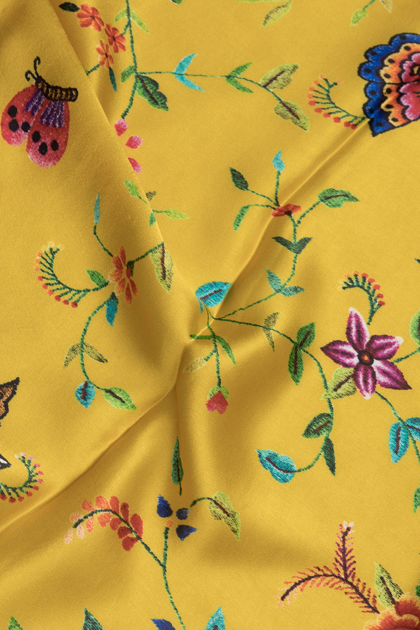 Close up of Yellow Dual Tone Crepe Saree with Printed design on the body and Printed Border.  displaying folds