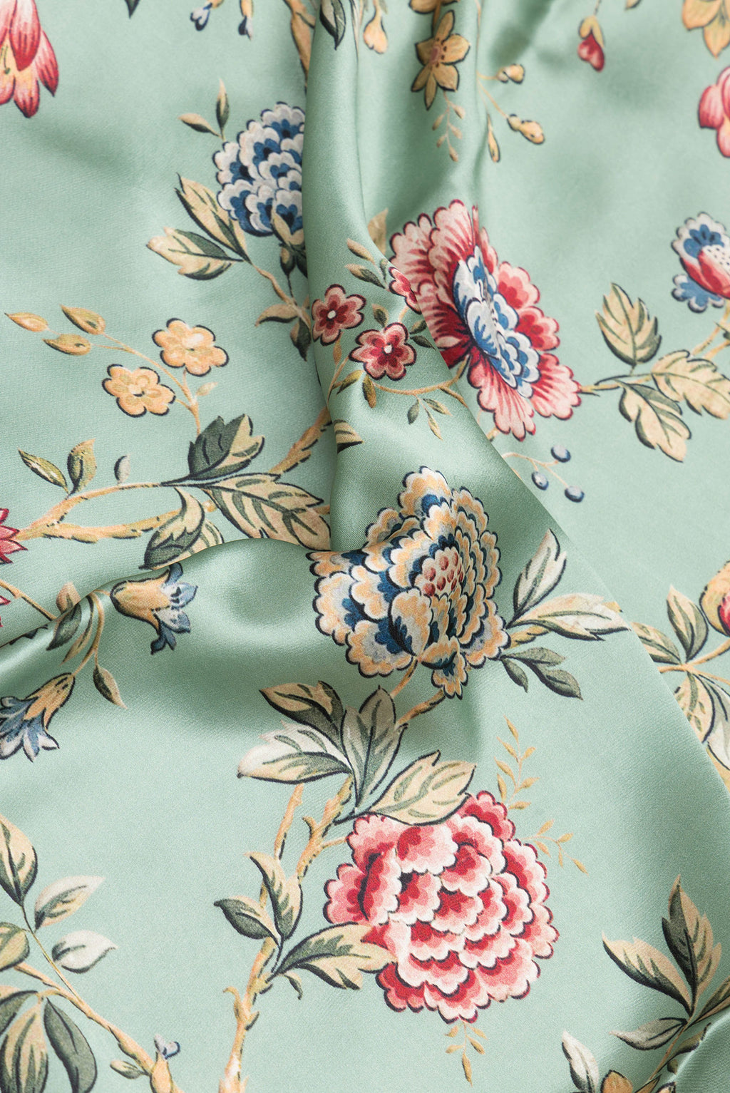Close up of Pista Green Crepe Saree with Printed design on the body and Printed Border.  displaying folds
