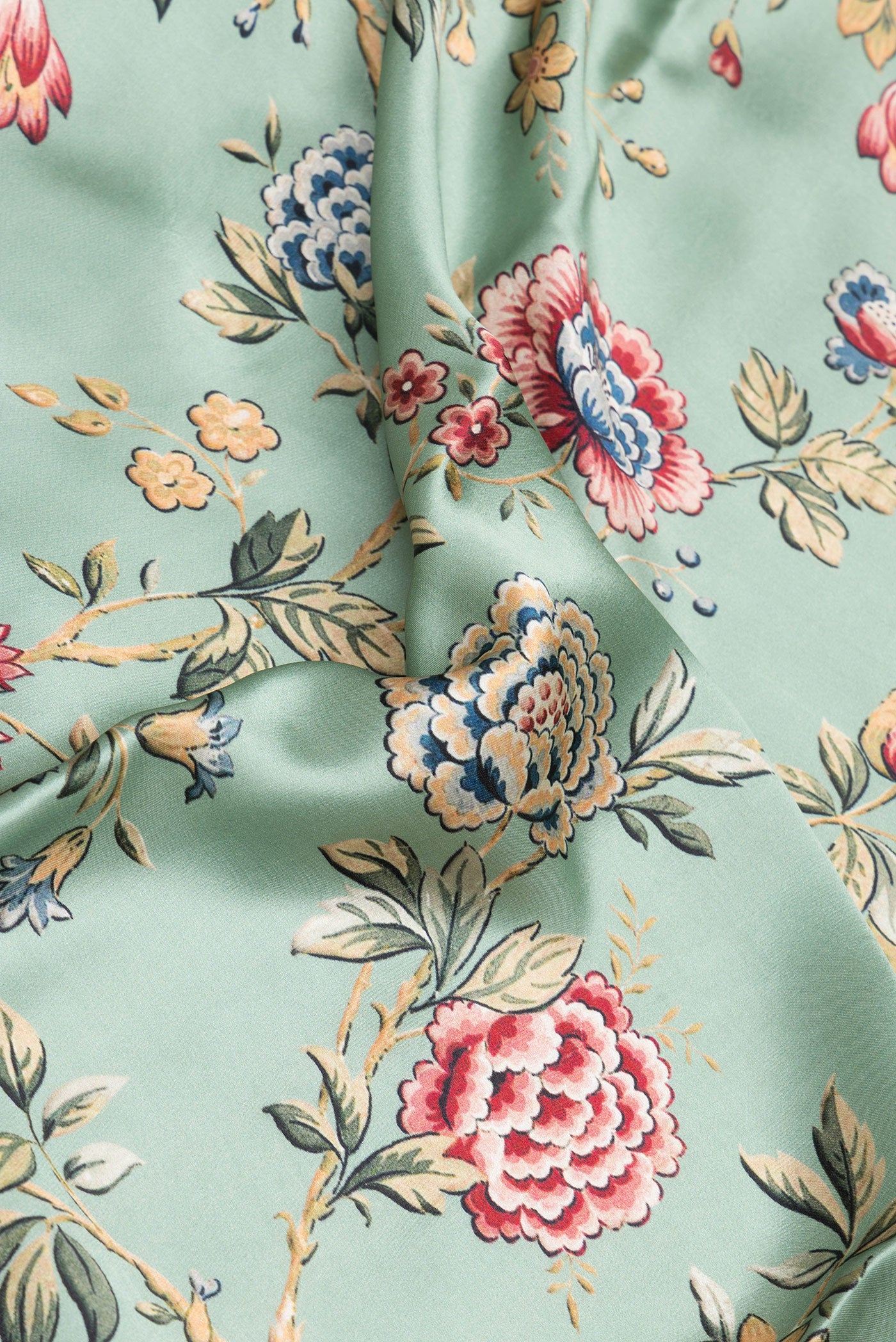 Close up of Pista Green Crepe Saree with Printed design on the body and Printed Border.  displaying folds